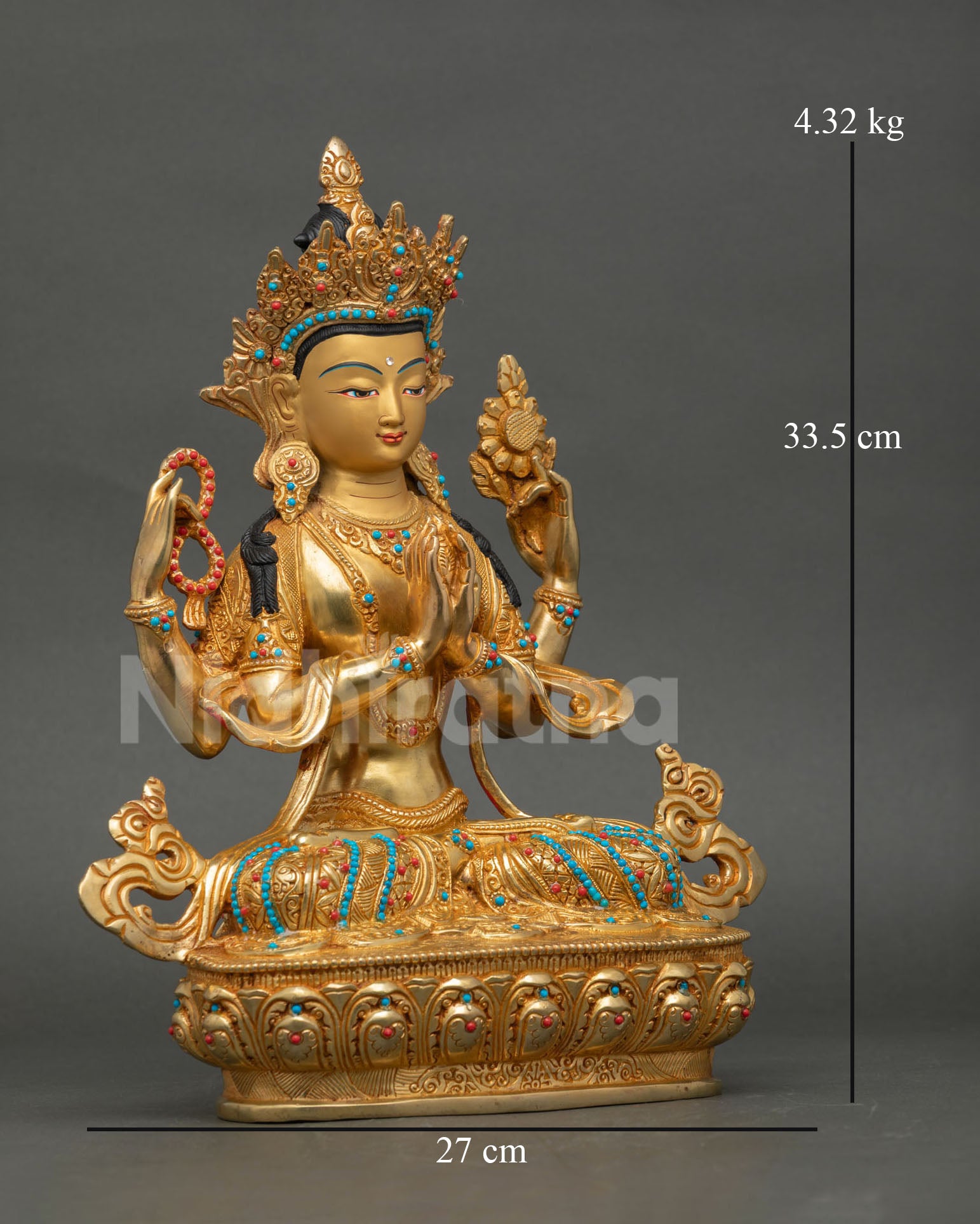 Side view of Chenrezig statue holding sacred attributes with swirling robes and decorative lower garments in Buddhist style