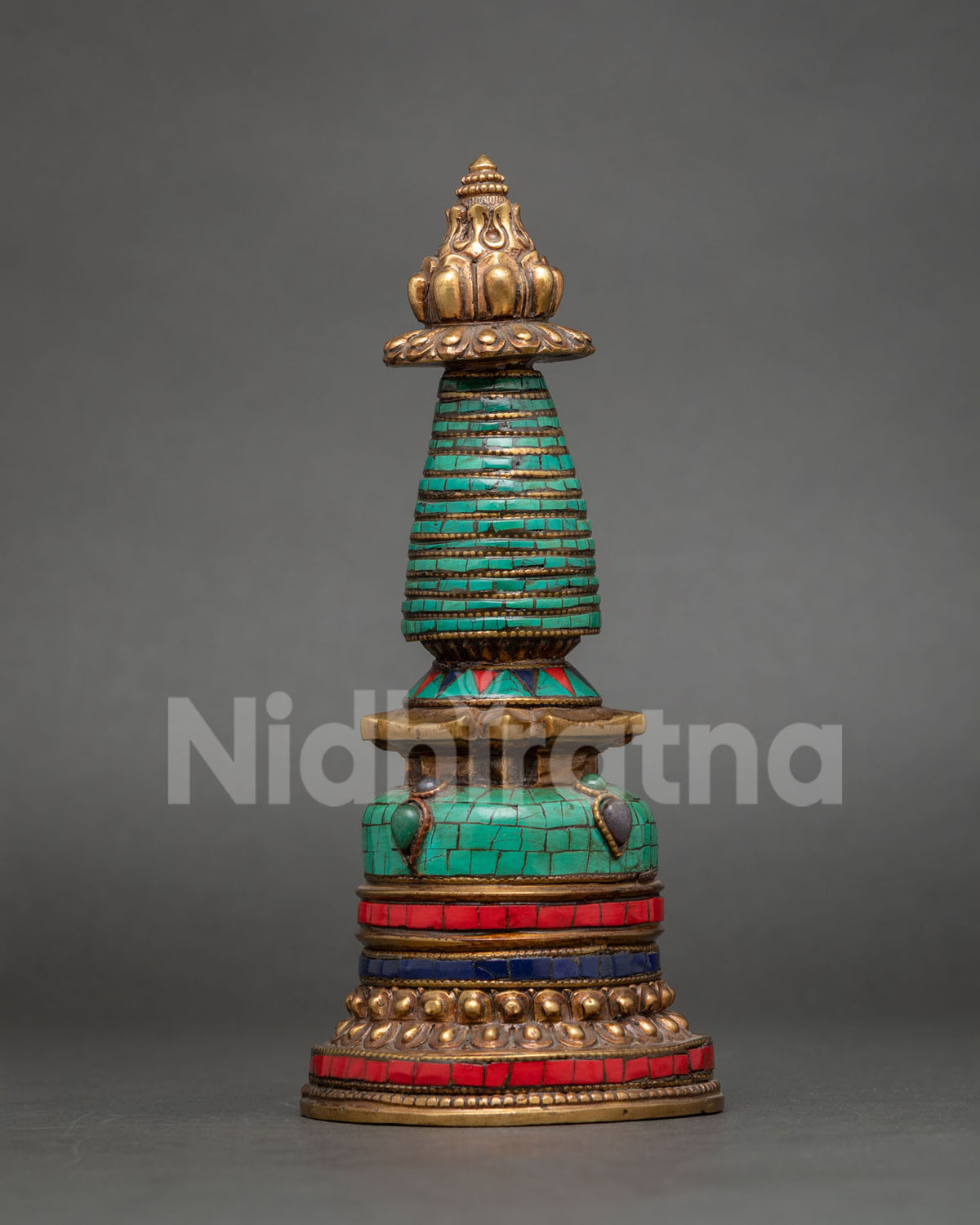 Side view of copper Kadampa Stupa with gold-plated details and traditional tiered design