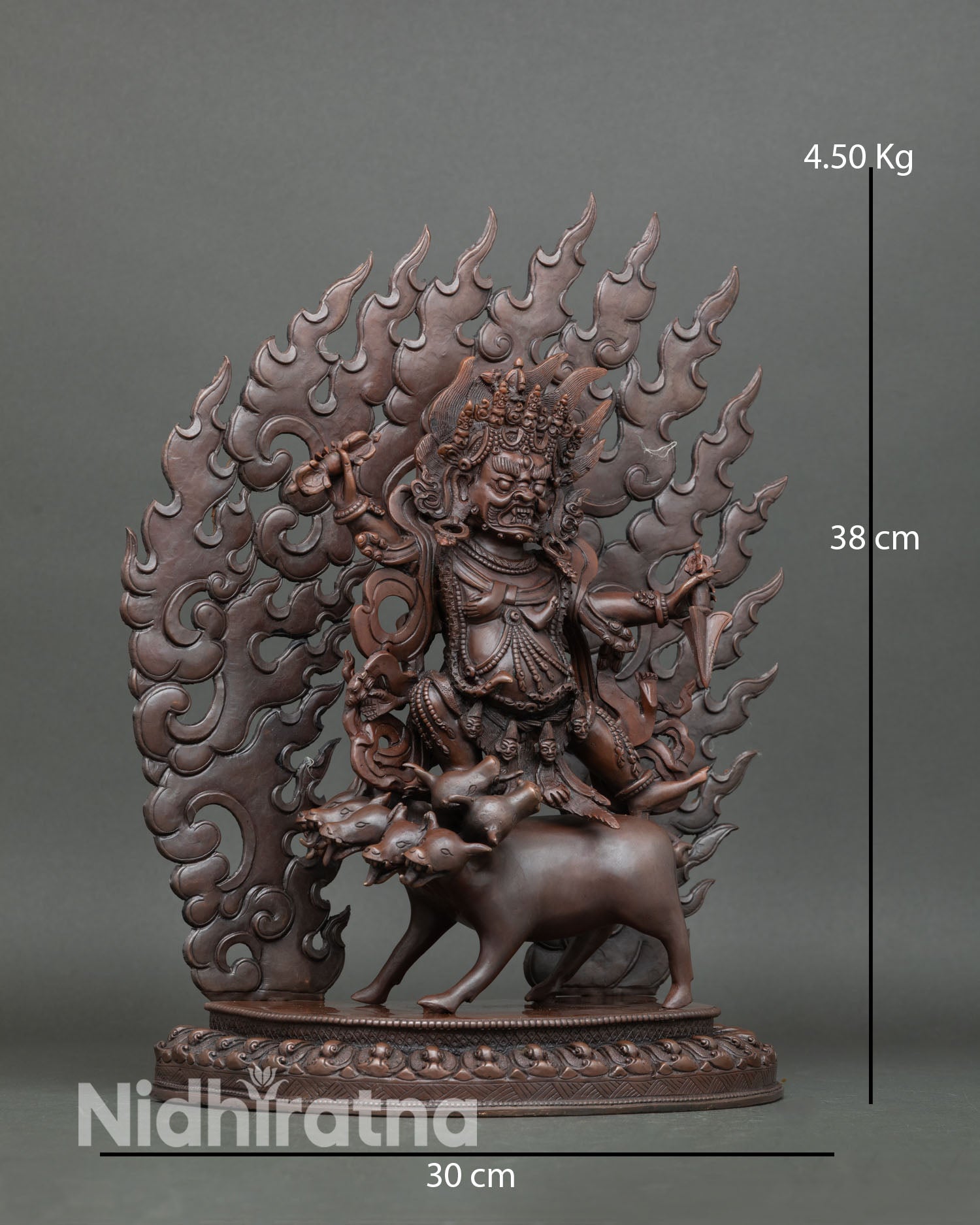 Side view of Dorje Gotrab statue riding buffalo surrounded by fire halo showing premium copper detailing oxidized texture