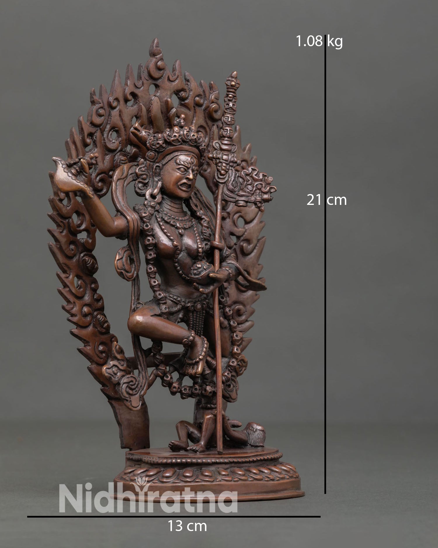 Side view of Dorje Phagmo in dancing posture holding kartika and kapala, oxidized copper tantric Buddhist deity statue in Himalayan art style.