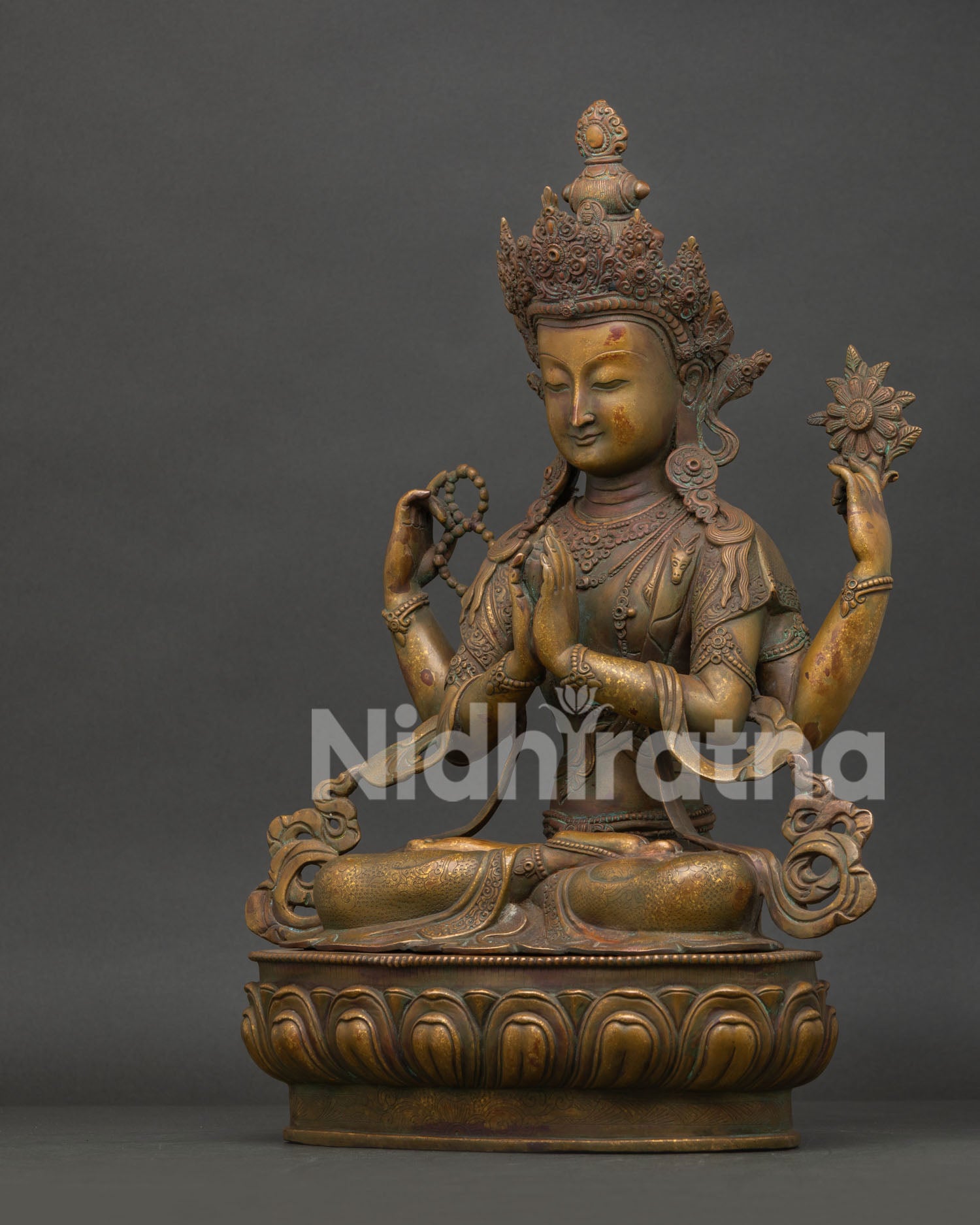 Side view of Four Armed Chenrezig statue showing intricate lotus seat and artisan craftsmanship.