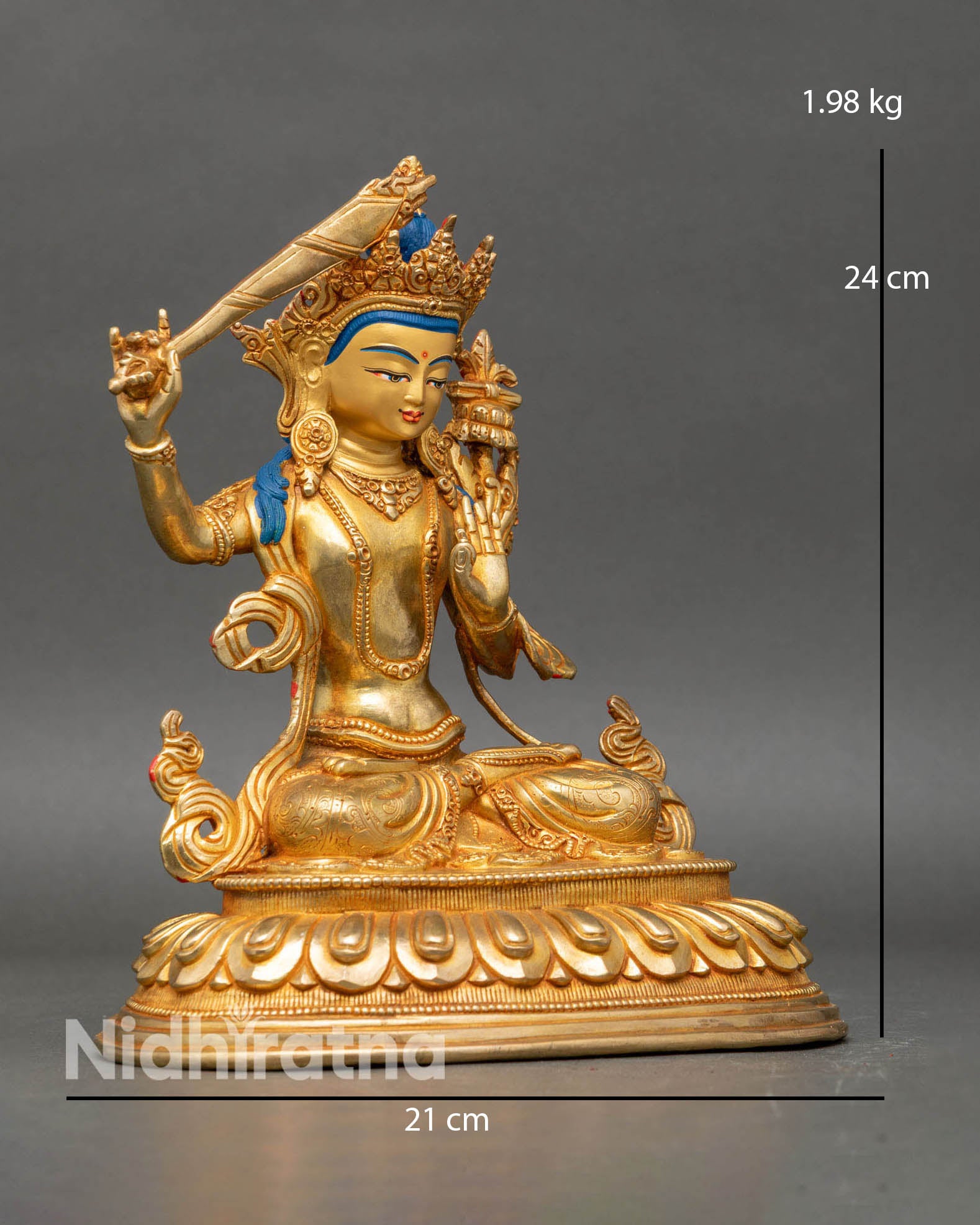 Side view of four-armed Manjushri statue holding the flaming sword of wisdom and the Prajnaparamita scripture.