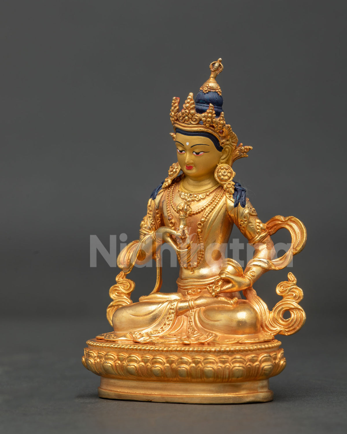 Side view of gold fire gilded Vajrasattva statue with celestial scarf and floral silk garment.