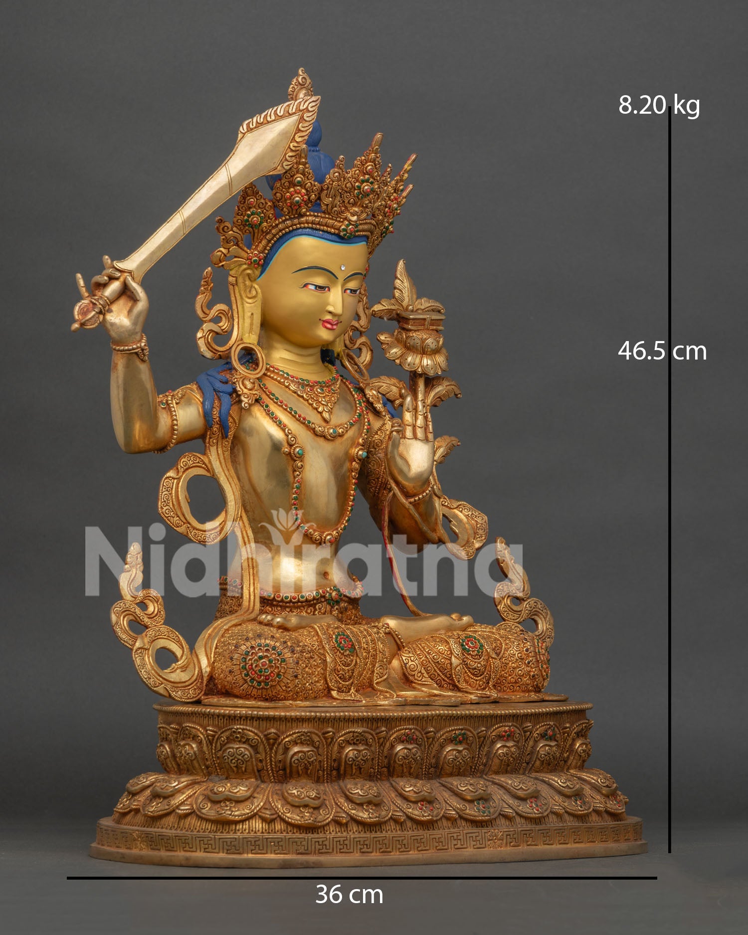 side view of gold gilded manjushri buddhist statue with intricate carvings