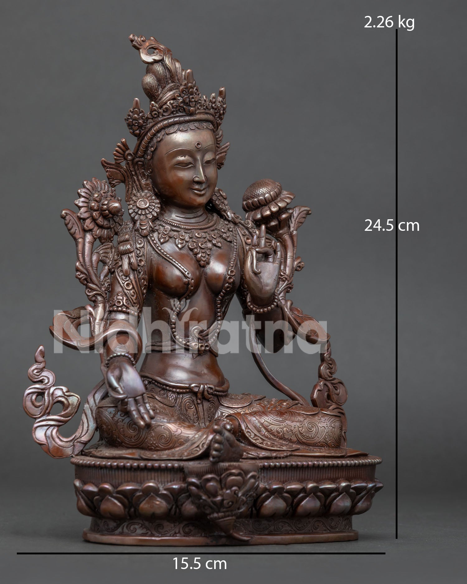 Side view of Green Tara Buddhist statue in Lalitasana posture with lotus flower
