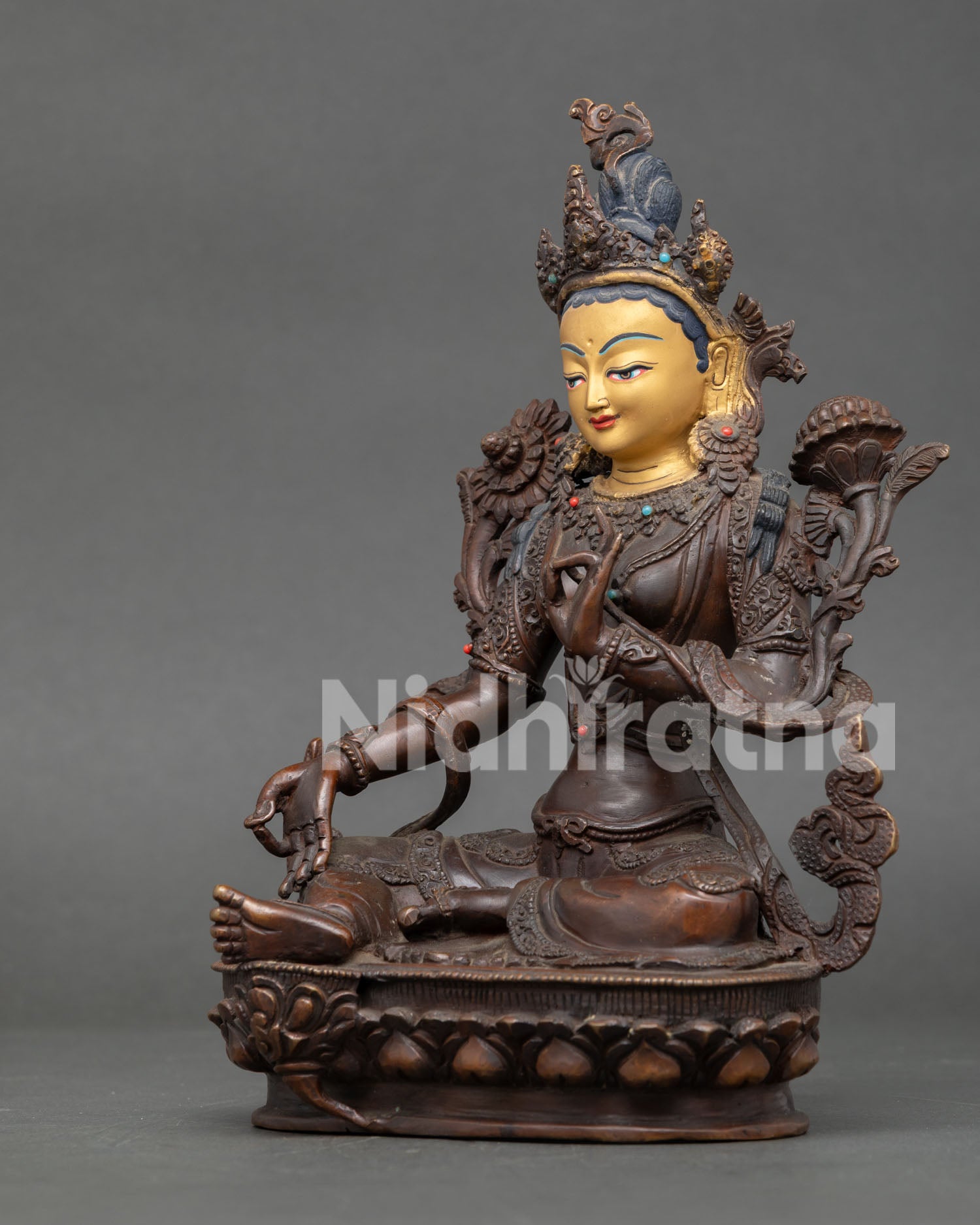 Side view of Green Tara Statue in Lalitasana on lotus throne handcrafted by Newari artisans.