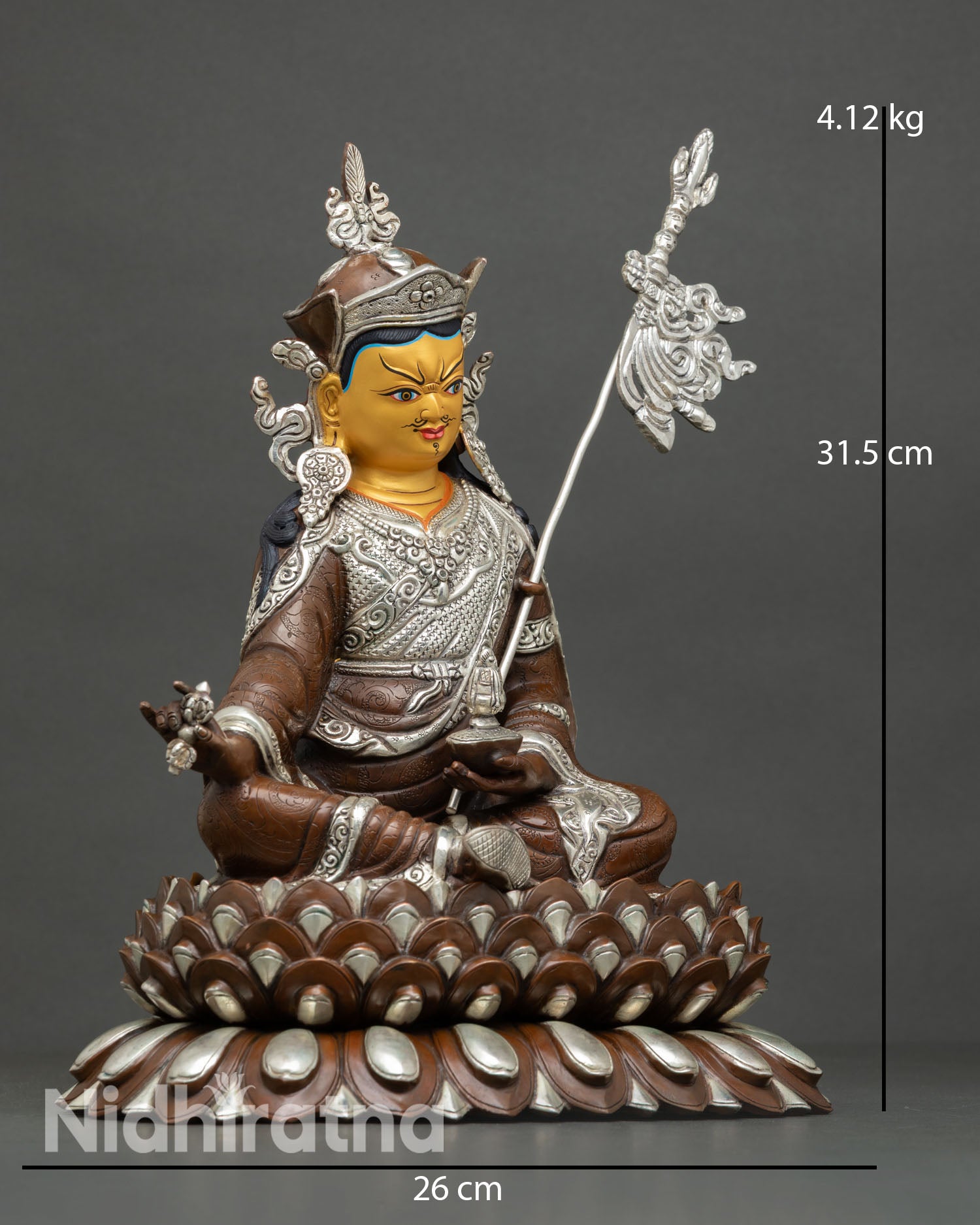 Side view of Guru Rinpoche statue showing vajra skull cup khatvanga staff layered robes and silver plated oxidized sacred Buddhist artistry