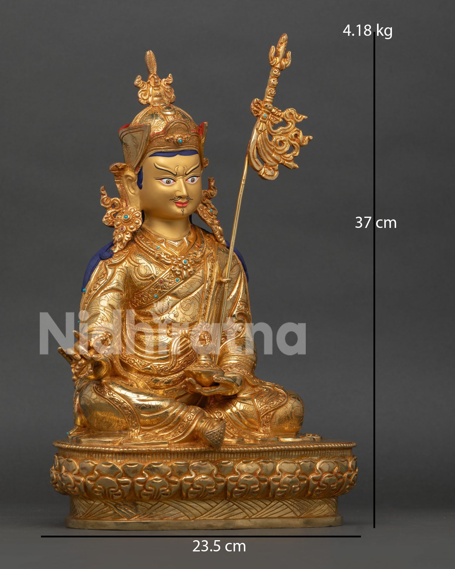 side view of guru rinpoche statue with vajra khatvanga and traditional himalayan artistry