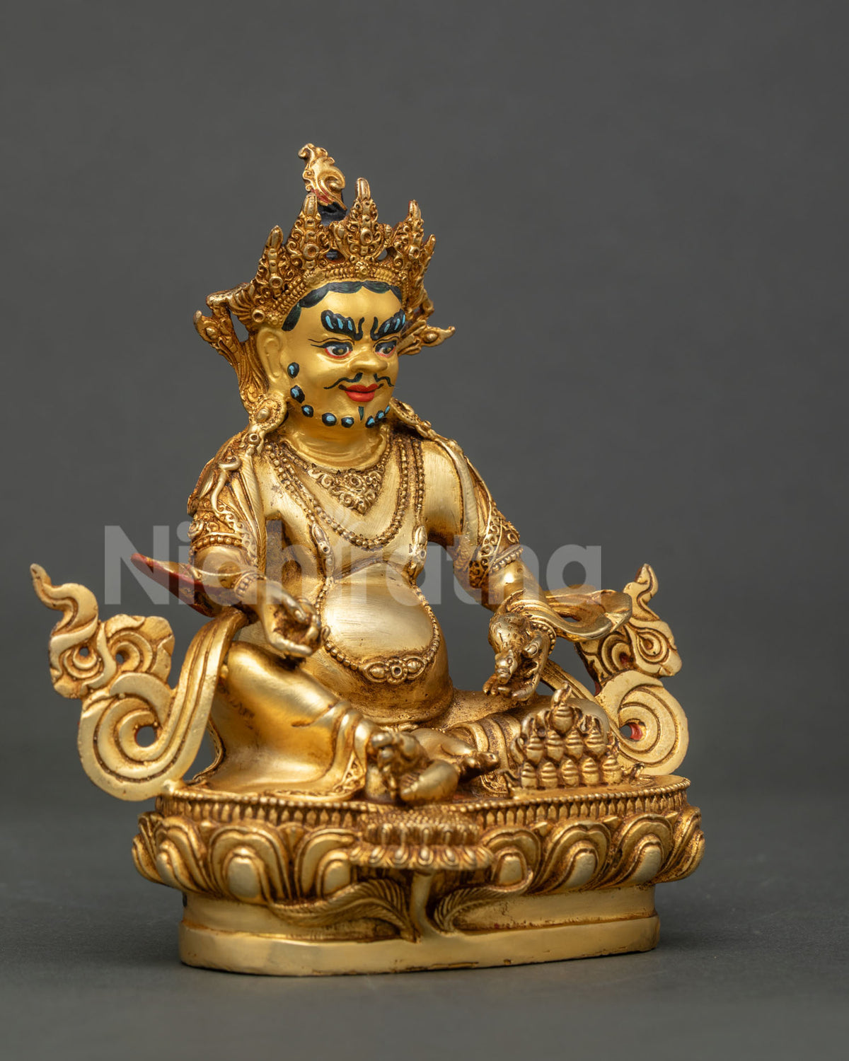 Side View of handcrafted dzambhala statue showing copper body gold finish and intricate newari craftsmanship.