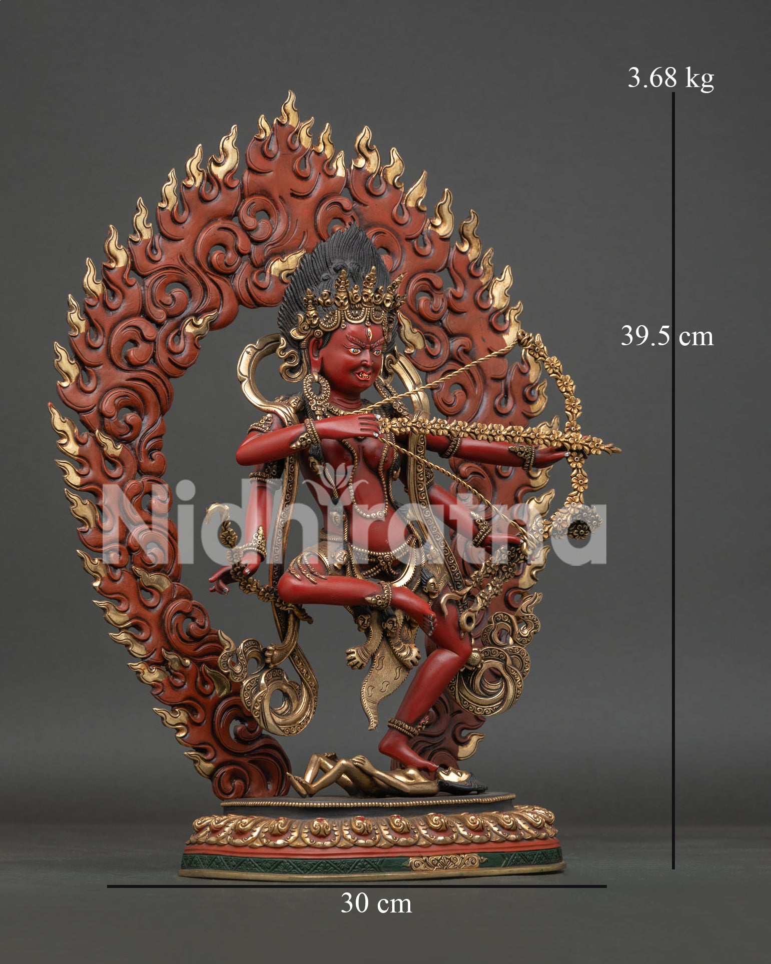 Side view of Kurukulla Statue with four arms holding flower, bow, hook and a noose