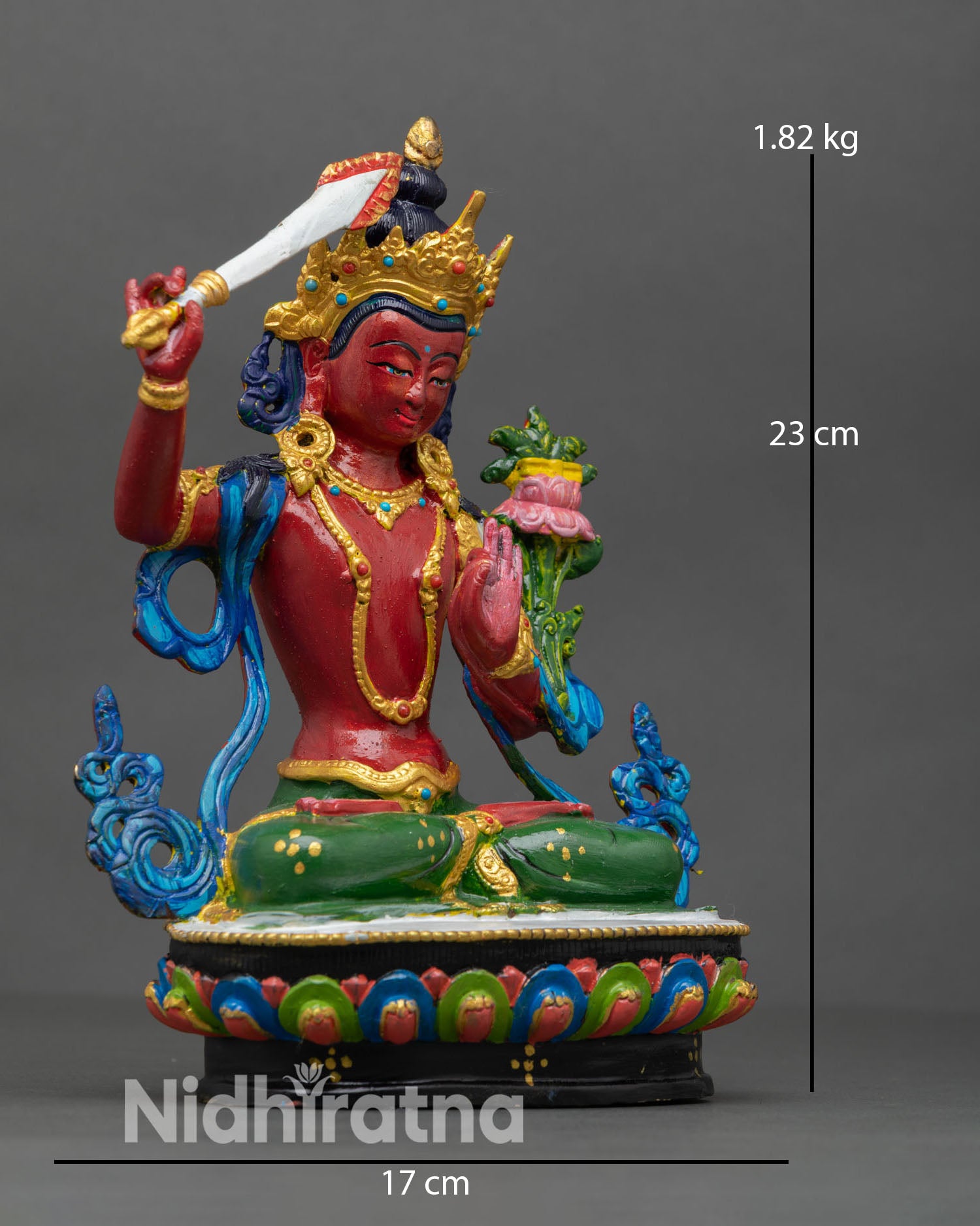 Side view of Manjushri statue depicting flowing floral robes multi colored lotus pedestal and refined Himalayan craftsmanship.