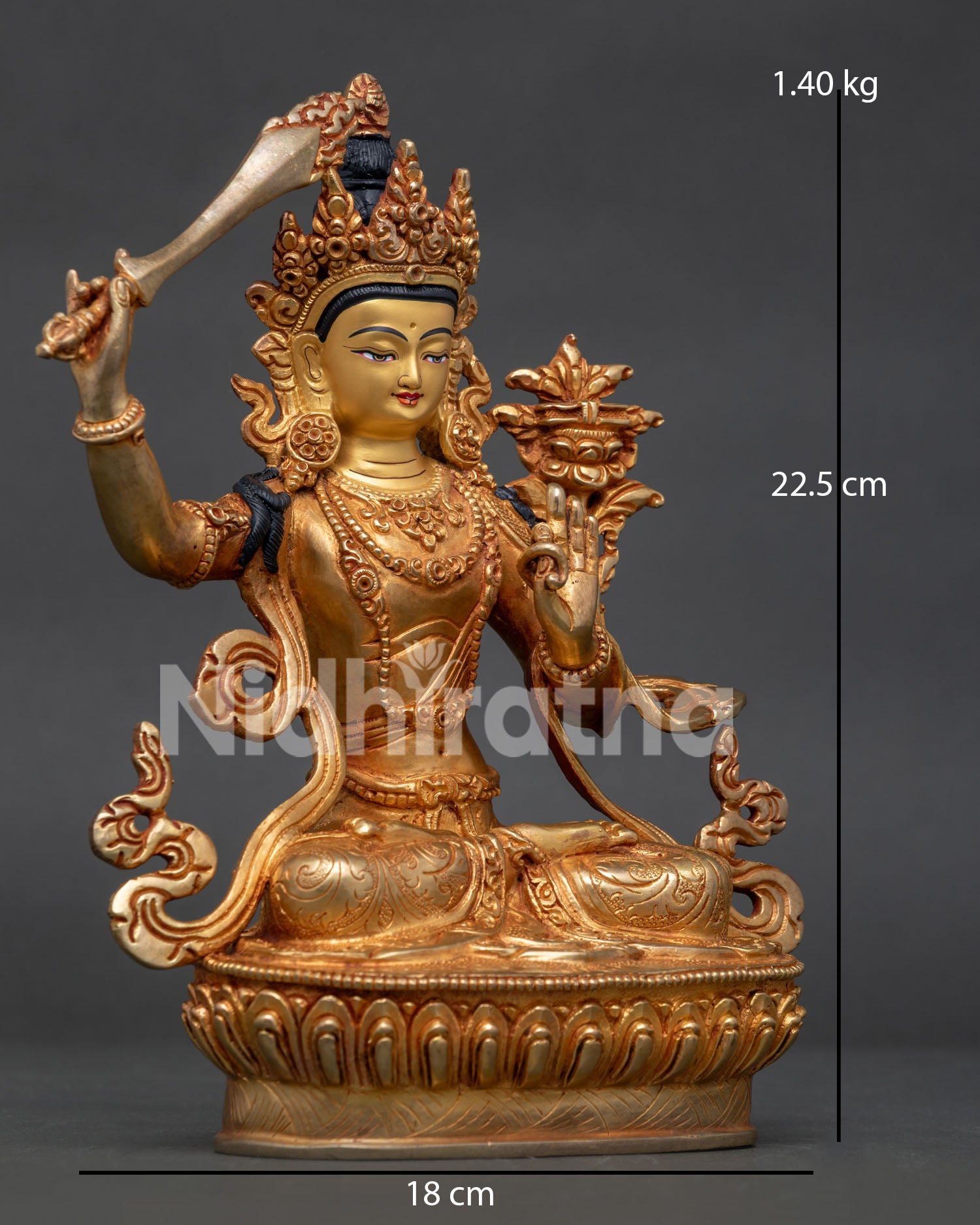 Side view of Manjushri statue holding flaming wisdom sword and utpala flower lotus