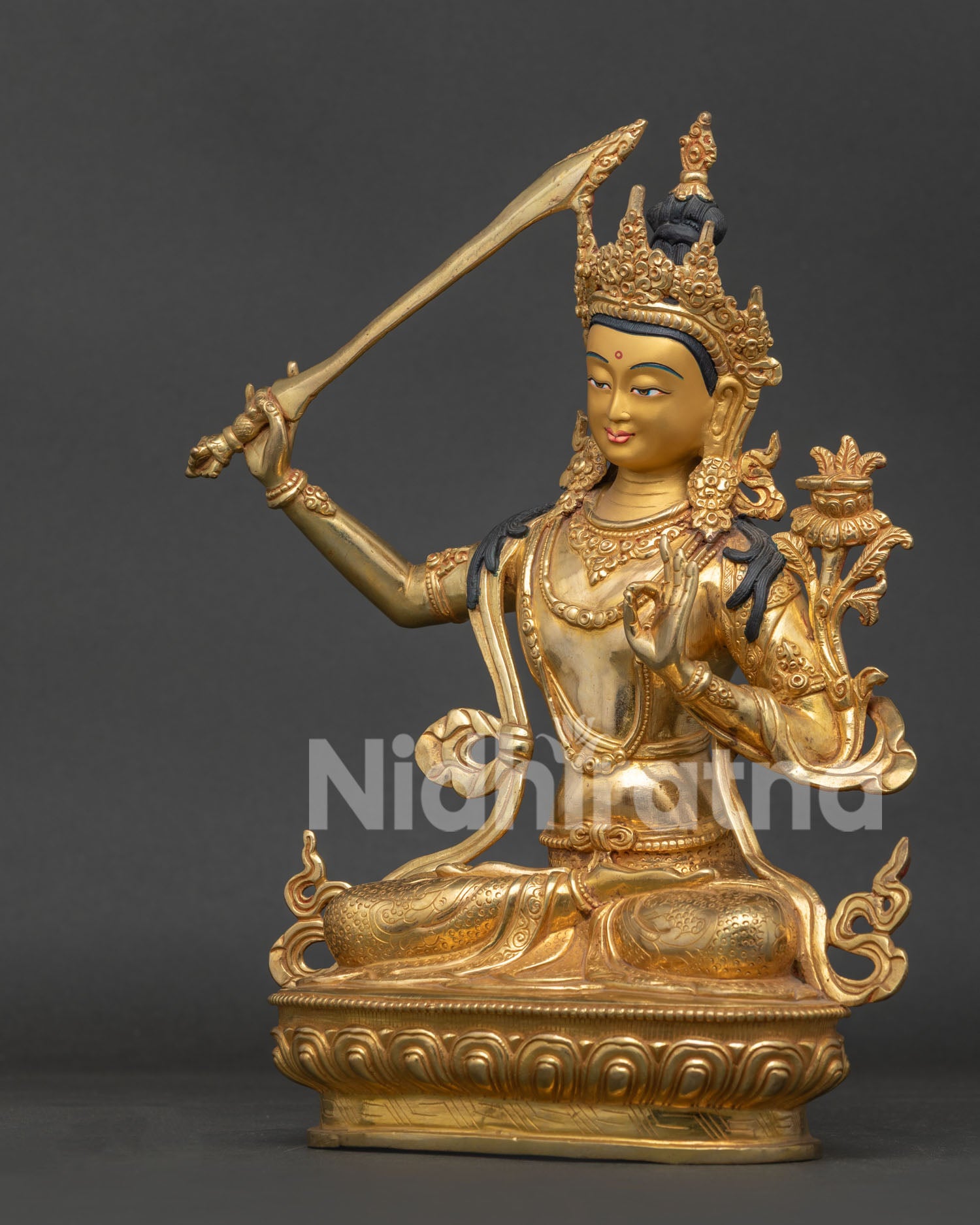 Side view of Manjushri statue showing handcarved vajra lotus seat and intricate details.