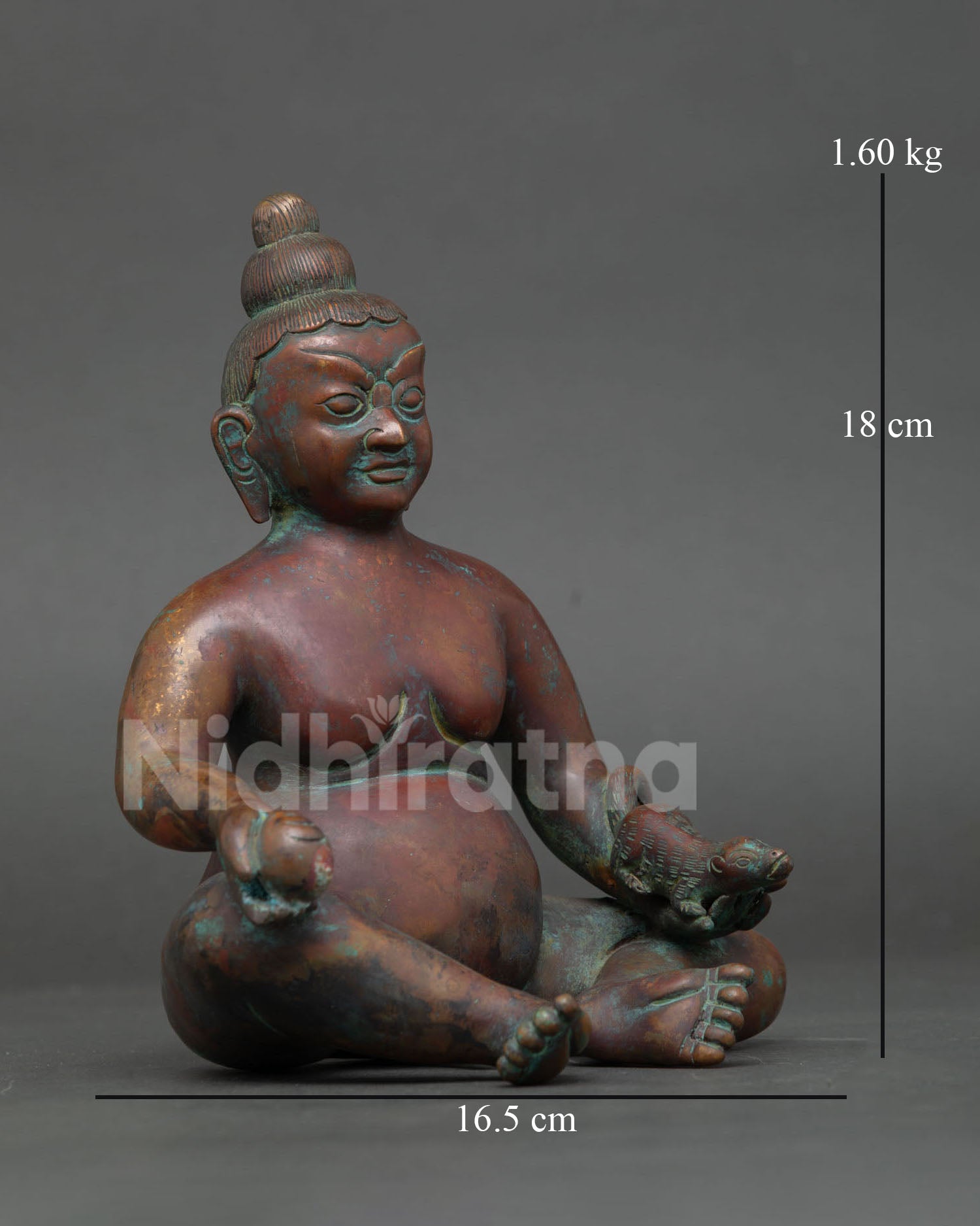 side view of oxidized copper dzambhala sculpture with traditional himalayan details