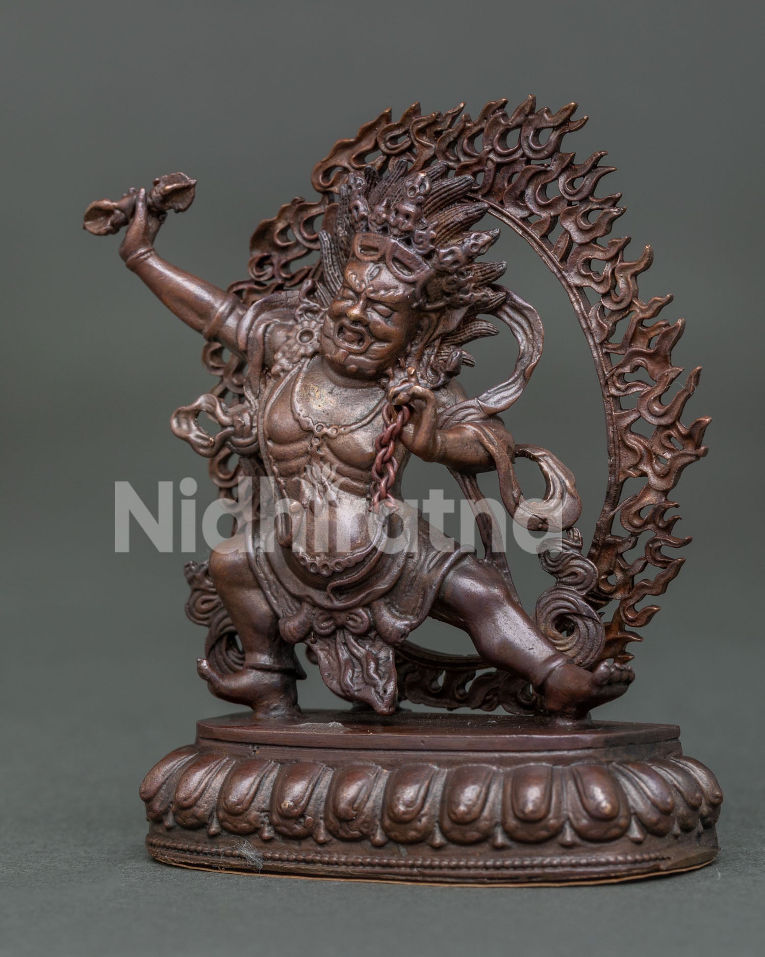 Side view of oxidized copper Vajrapani Statue showing tiger skin garment and sacred lasso.