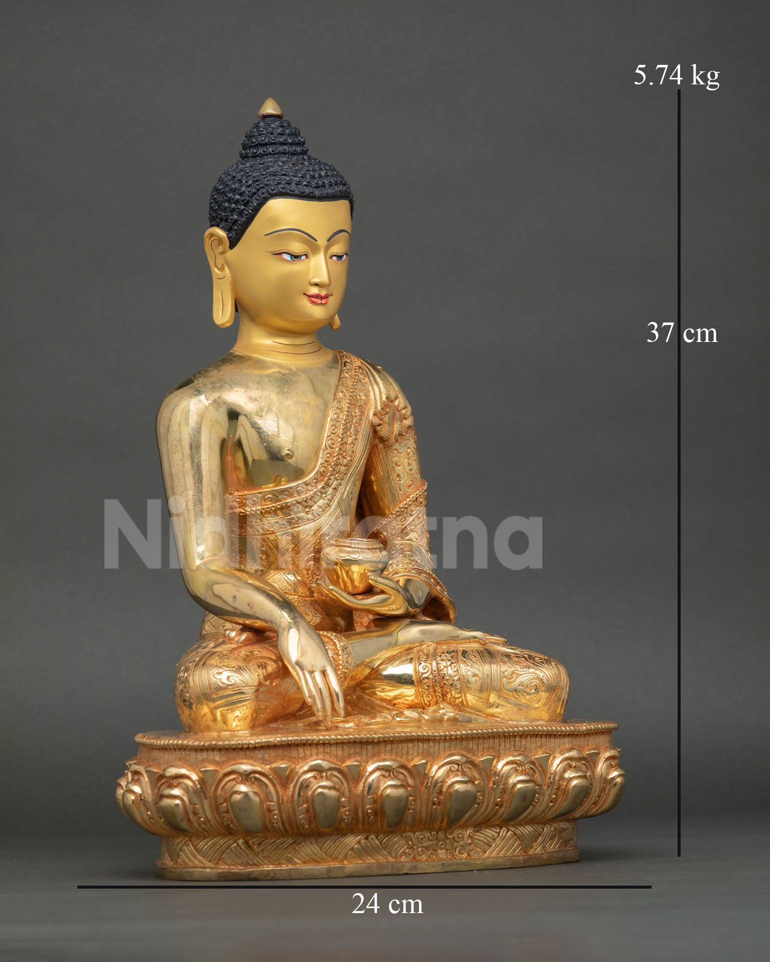 Side view of seated Buddha Shakyamuni statue on lotus pedestal showing copper body and gold gilded finish