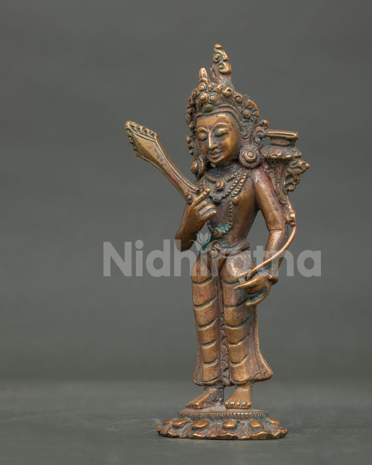 Side view of standing Manjushri holding flaming sword with prajnaparamita scripture.