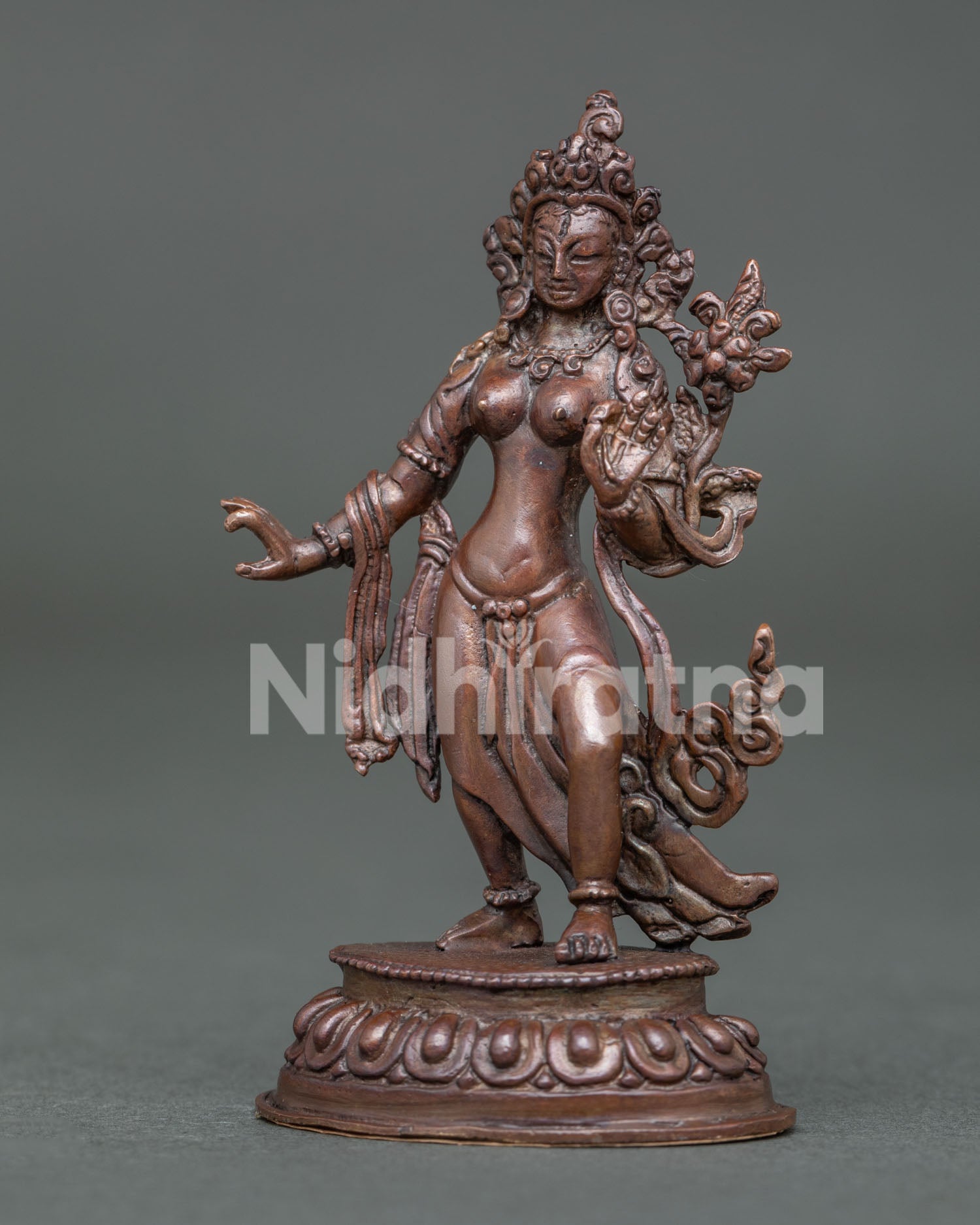 Side View of Standing White Tara Statue with Varada Mudra and Lotus Base.