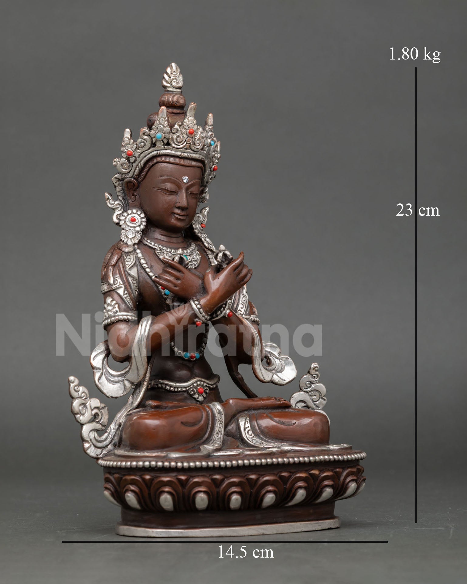Side view of Vajradhara statue depicting vajra in right hand bell in left hand and intricate Buddhist symbolism