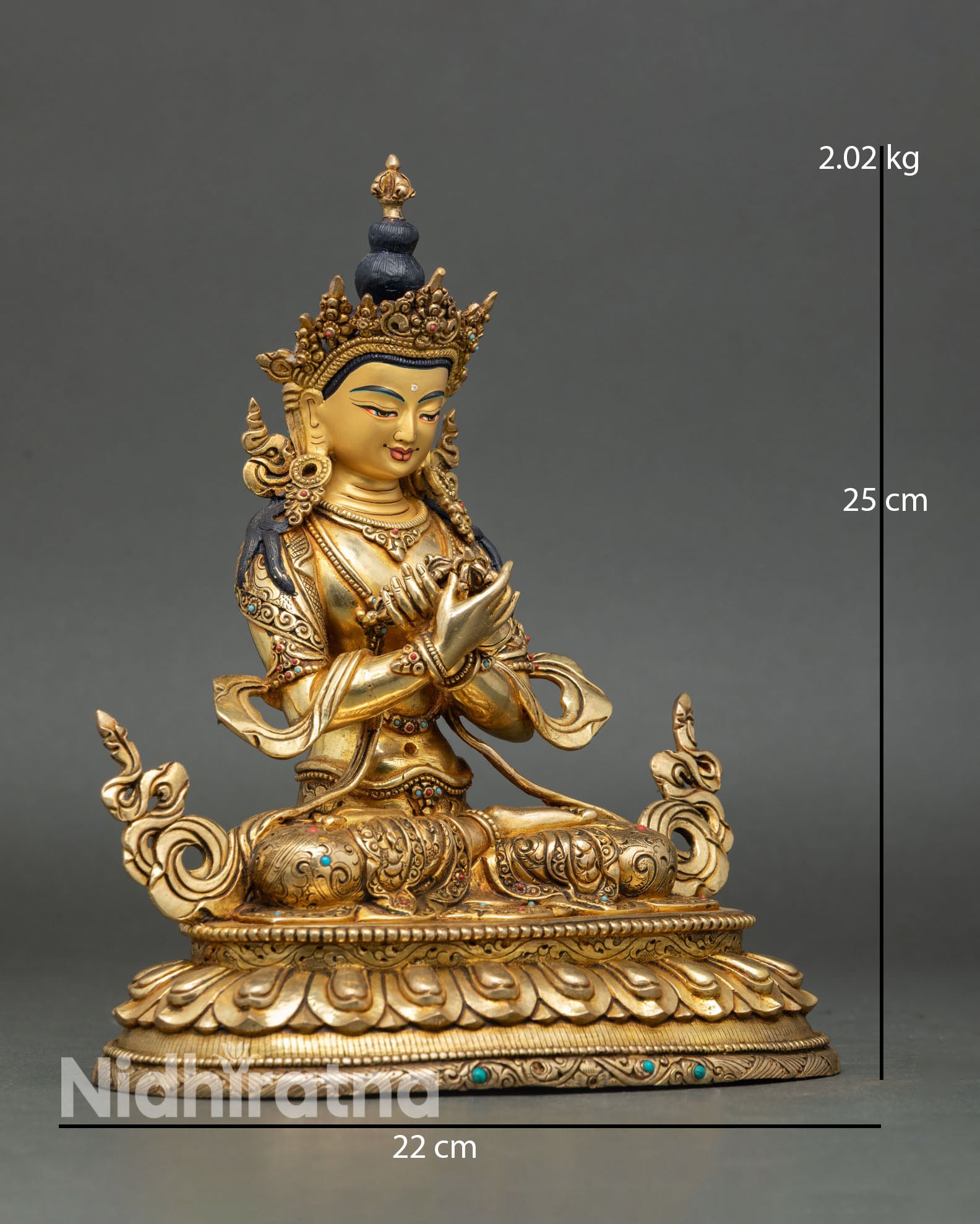 Side view of Vajradhara statue in arms crossed posture holding vajra and bell, Vajrayana Buddhist tradition