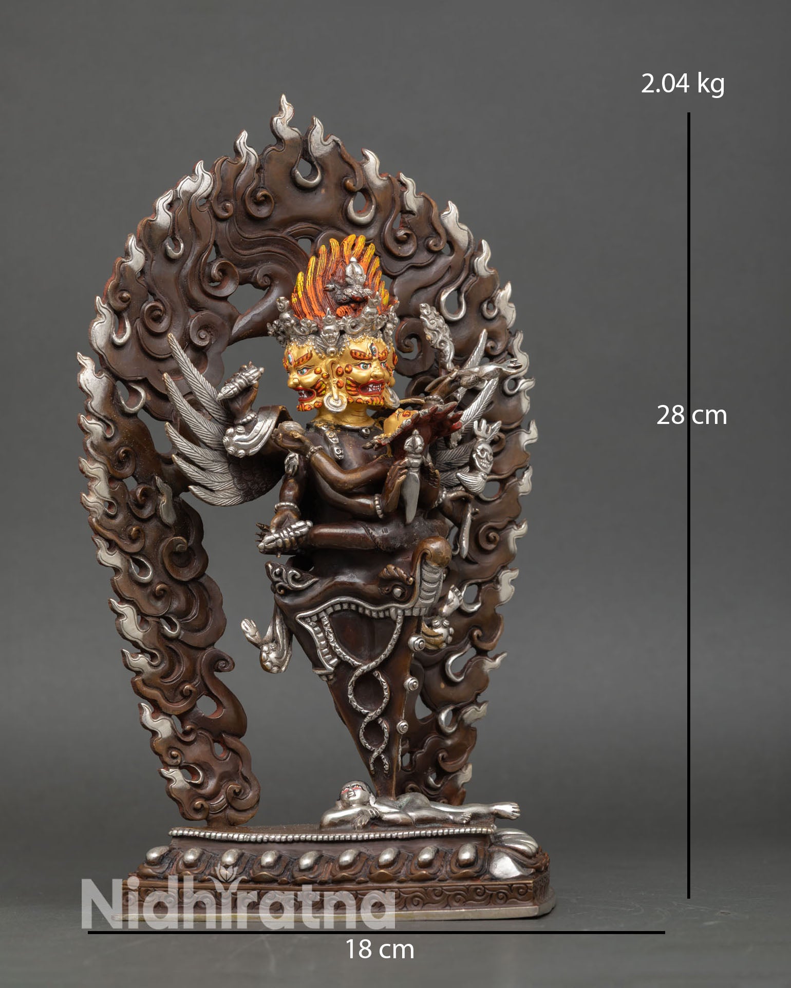 Side view of Vajrakilaya statue holding phurba, vajra, and ritual knife, a tantric deity for meditation decor.