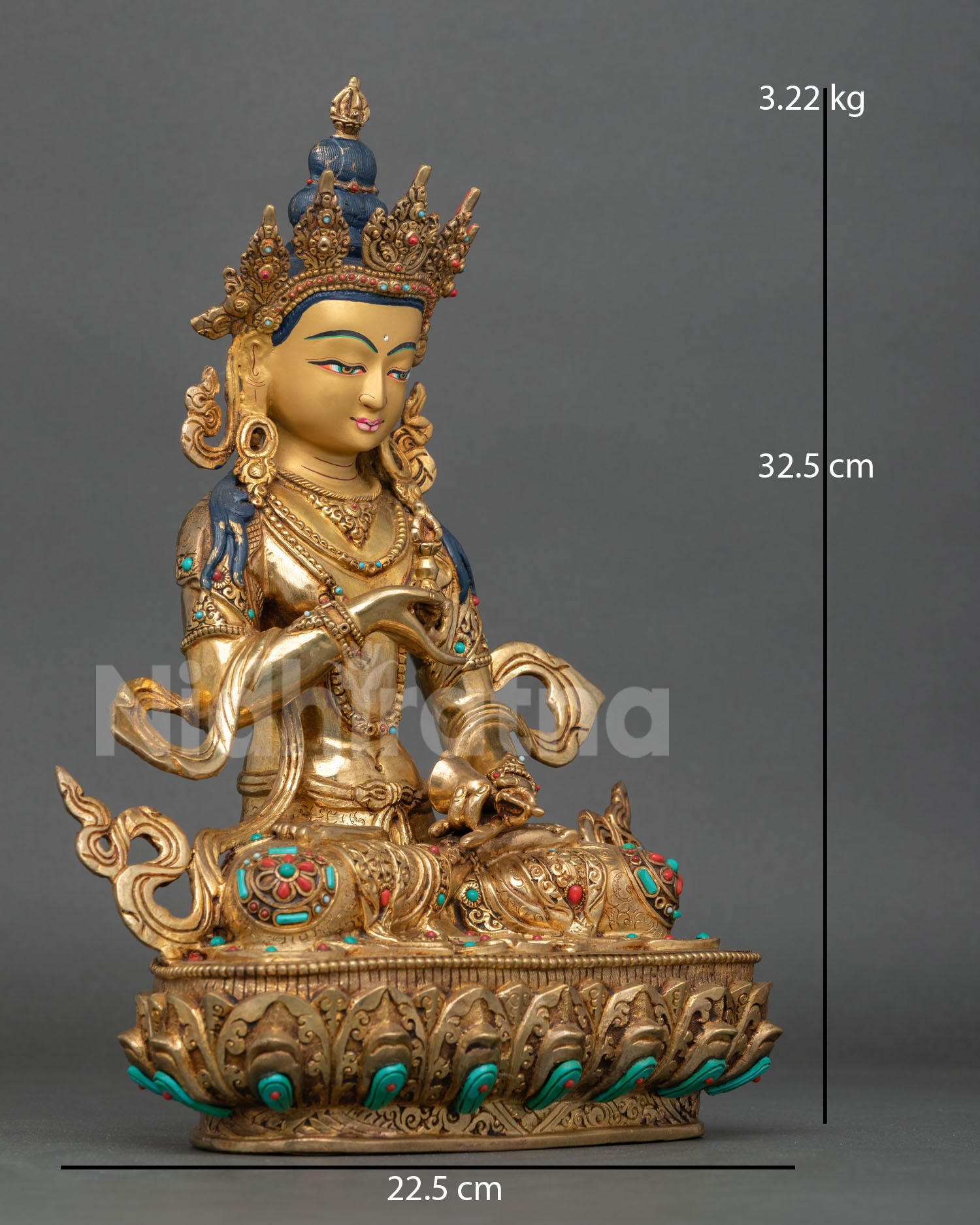 Side view of Vajrasattva holding vajra and bell with flowing robes and semi precious stones