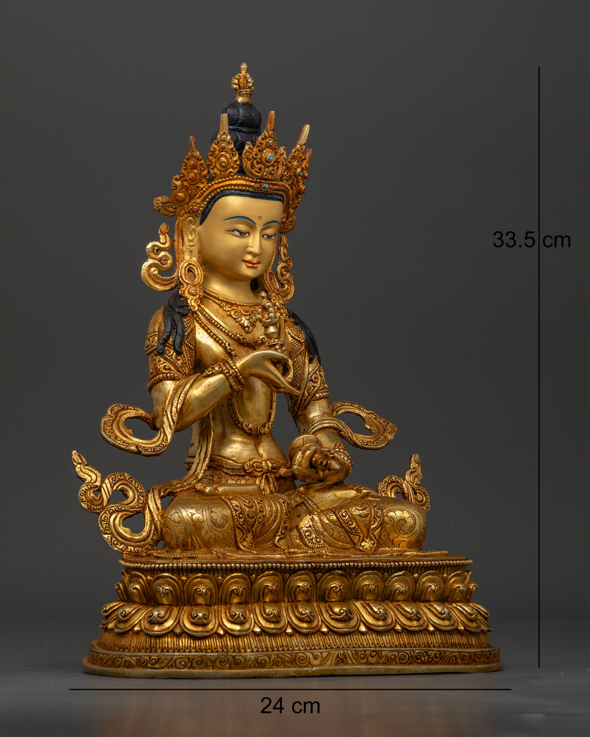 Side view of Vajrasattva statue seated on double lotus pedestal with sacred ornaments
