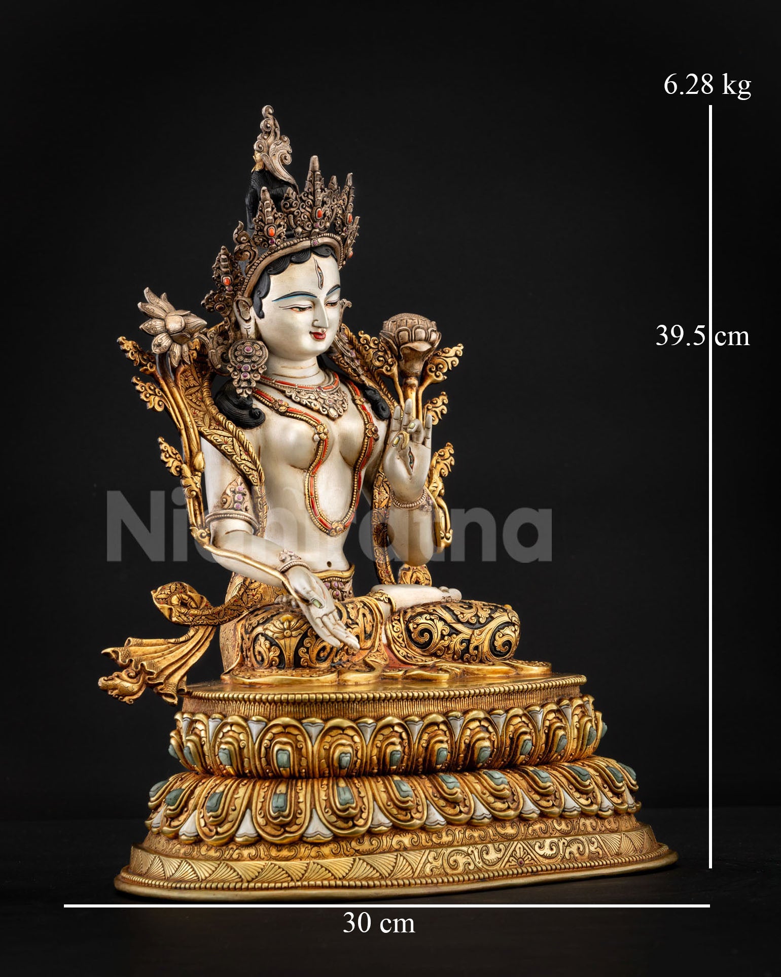 Side view of White Tara sculpture showing flowing robes semi precious stones and sacred ornaments