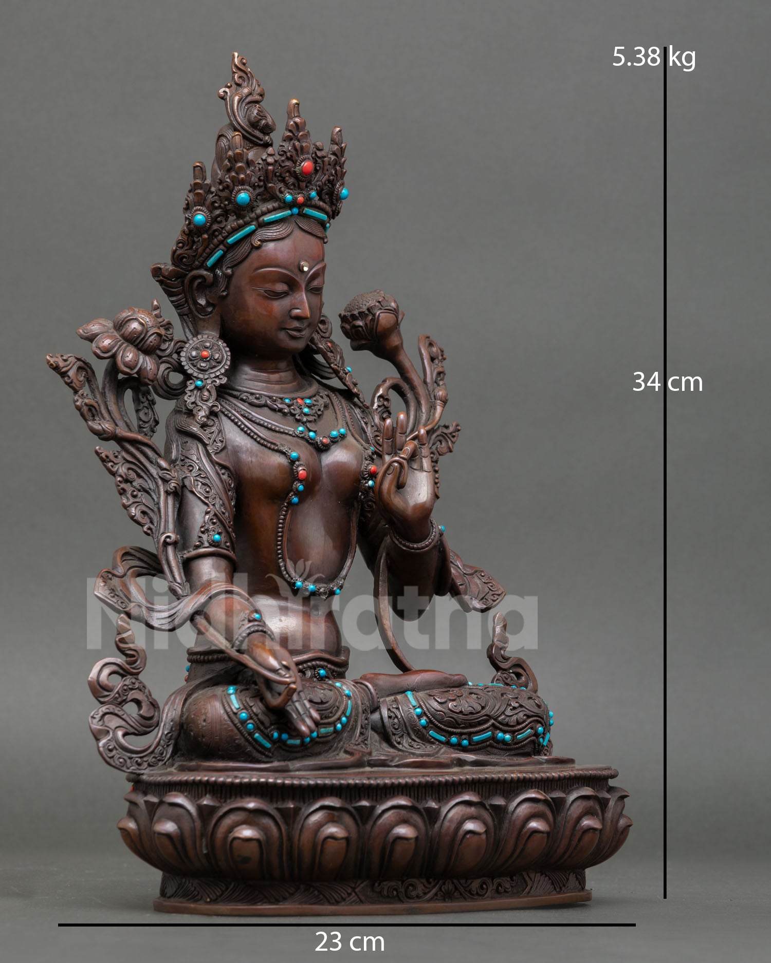 Side view of White Tara statue seated on a lotus throne, traditional Himalayan Buddhist altar sculpture design