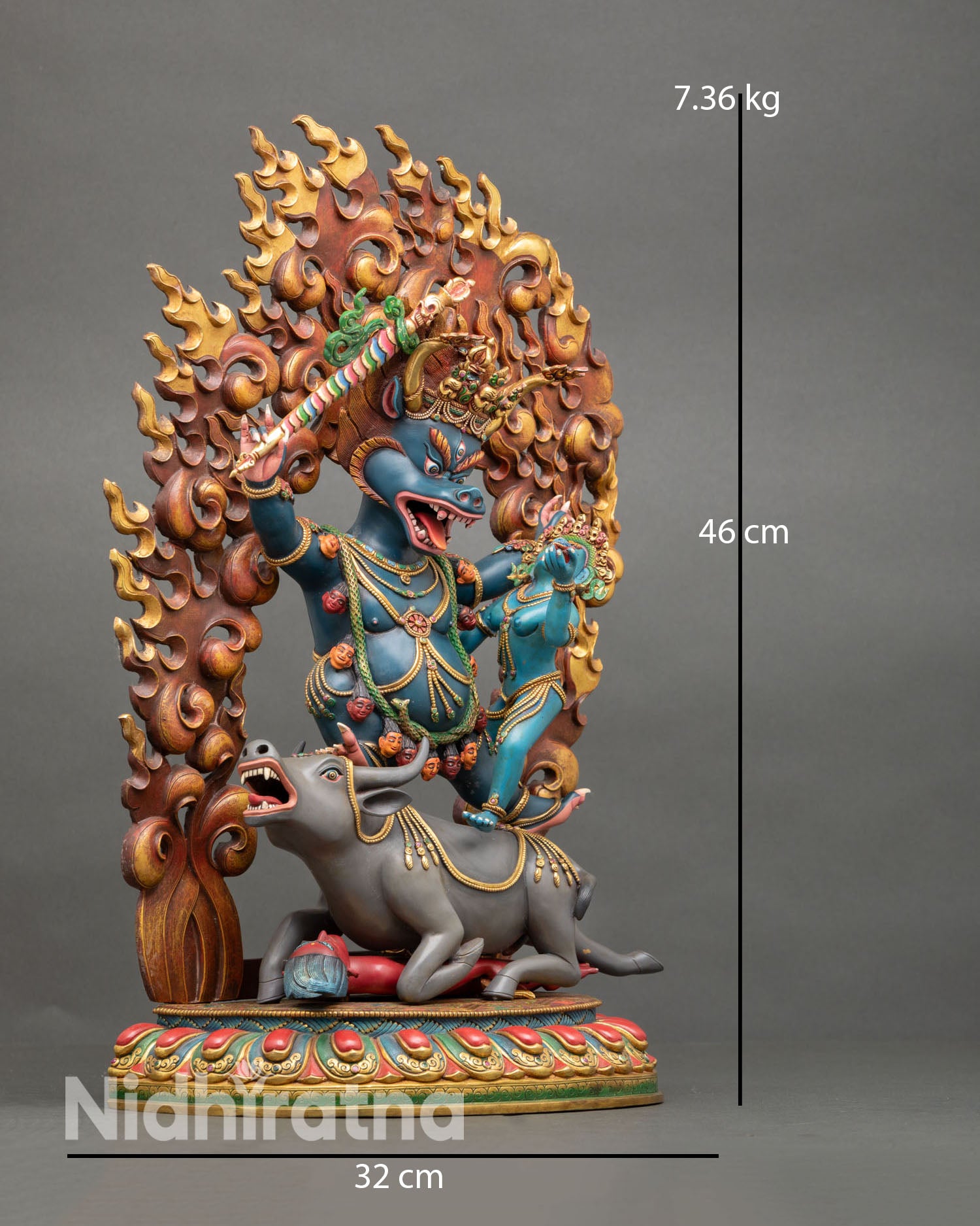 Side view of wrathful Yamantaka union statue standing on buffalo and lotus base symbolizing victory over ego, ignorance, and death in Vajrayana Buddhism