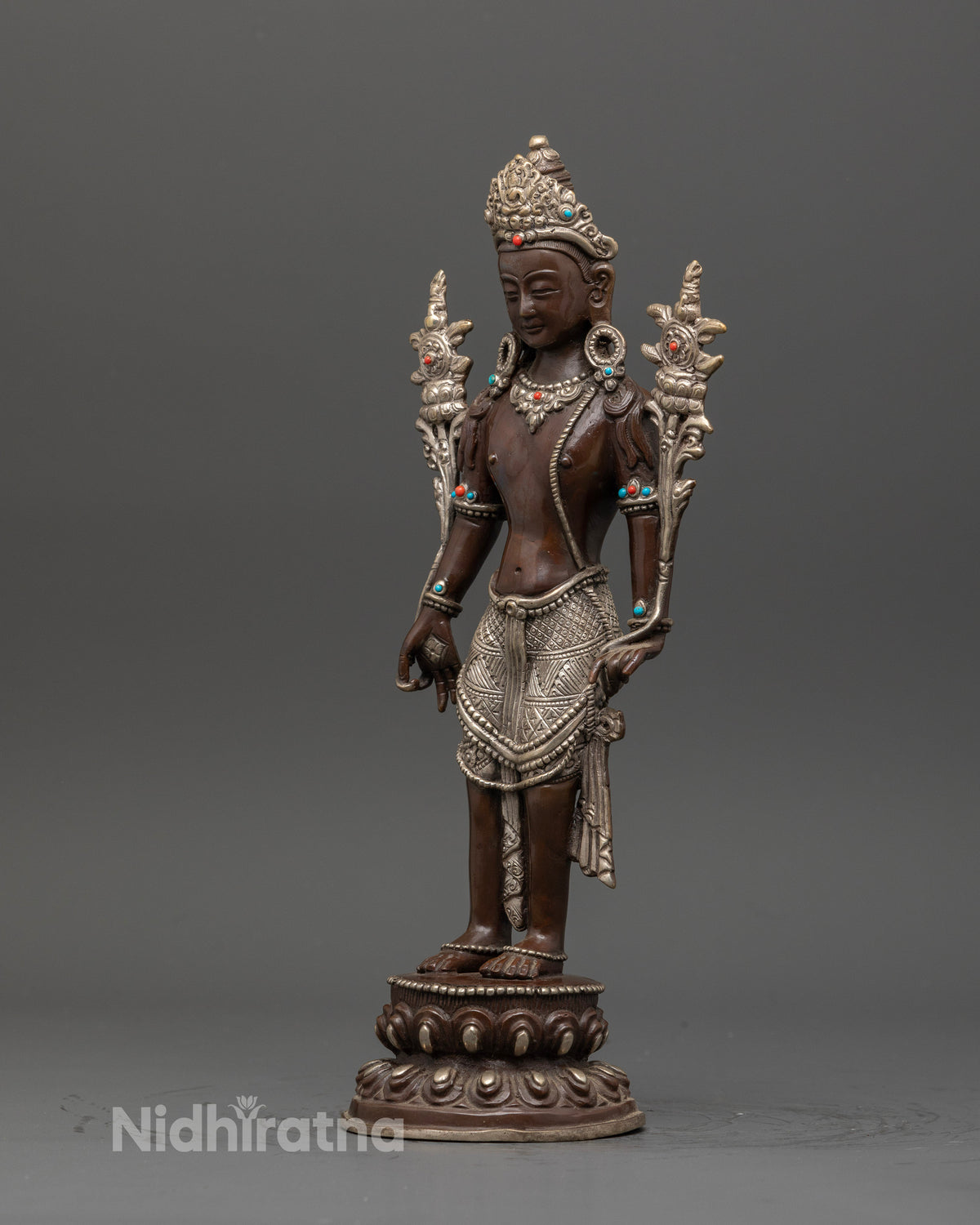 Side view Padmapani statue on double lotus pedestal with oxidized silver finish.