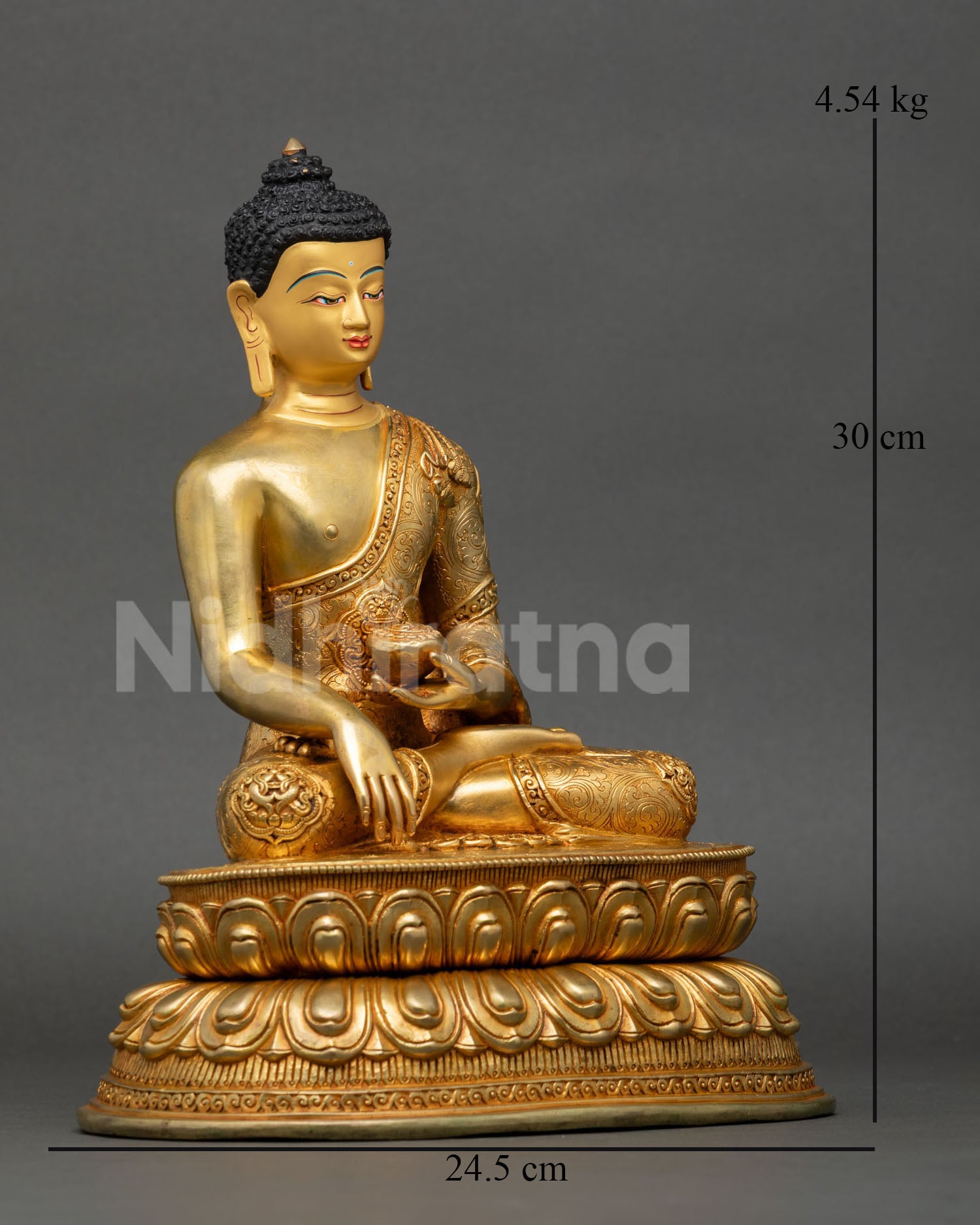 Side view of seated Shakyamuni Buddha statue on double lotus pedestal holding begging bowl with copper body and gold gilded finish for meditation decor