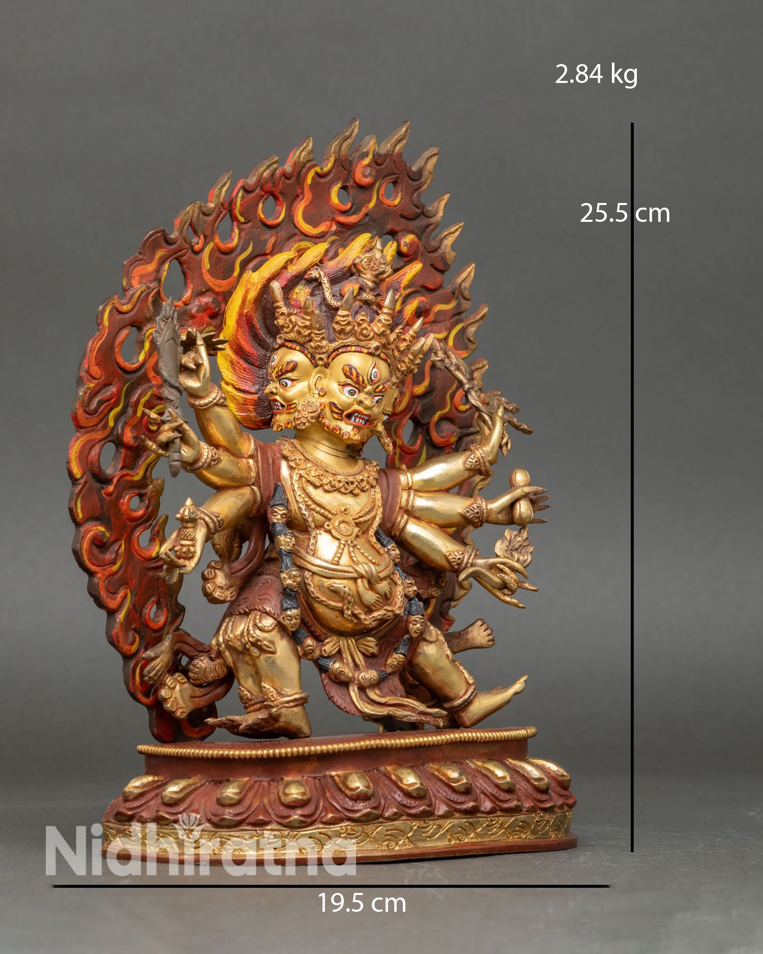 Side view of Six-Armed Mahakala statue holding ritual objects, lotus pedestal Vajrayana protector deity