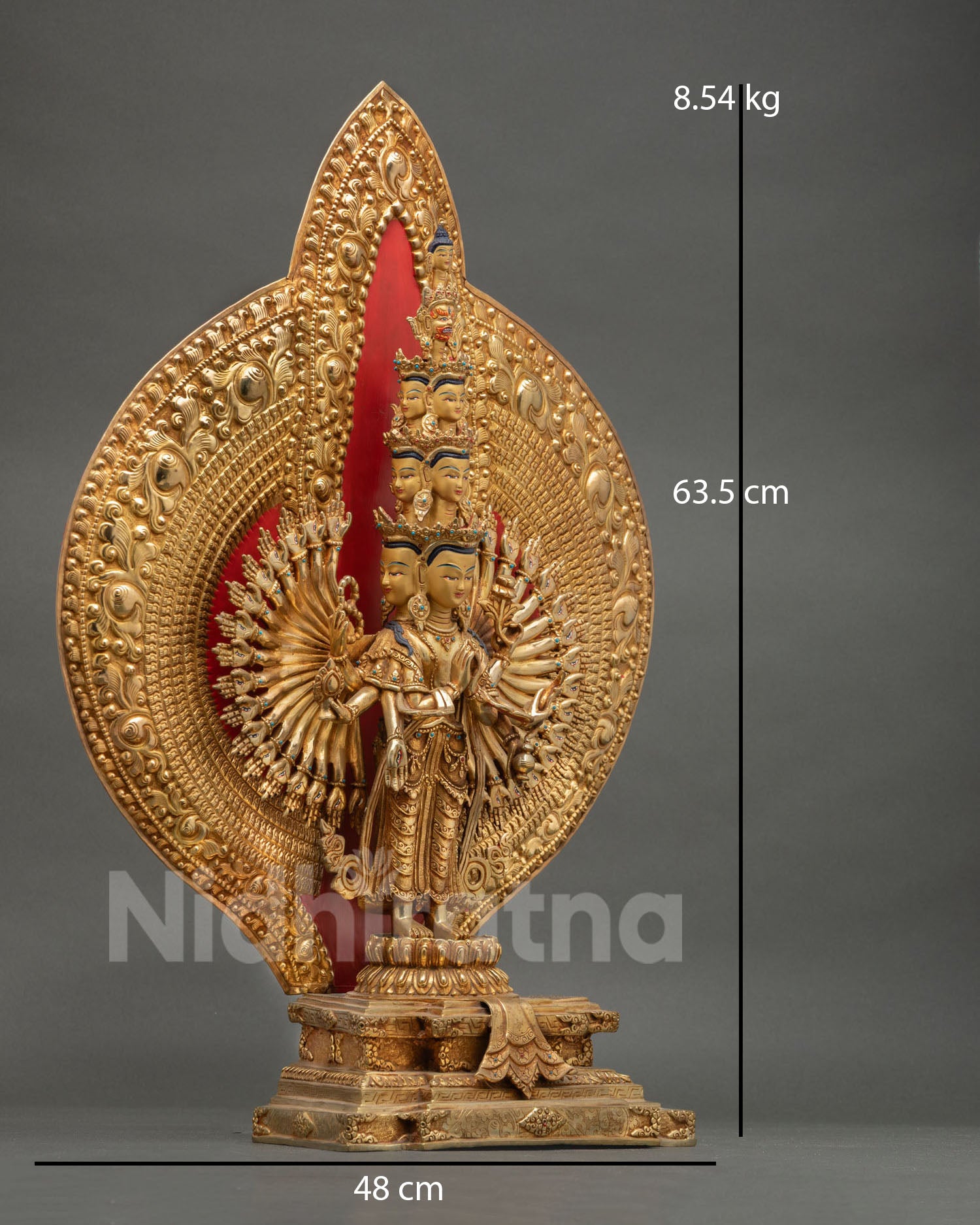 Side view of Thousand Armed Chenrezig statue with wish fulfilling jewel and intricate arm and robe carvings