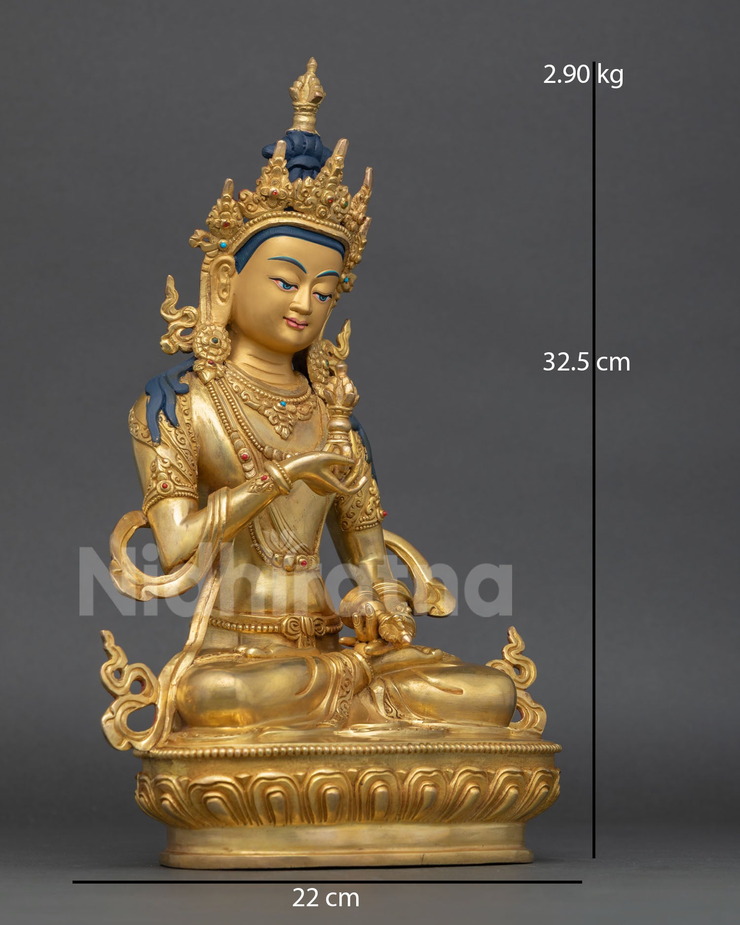 Side view of Tibetan Vajrasattva sculpture holding vajra and ritual bell on sacred lotus throne
