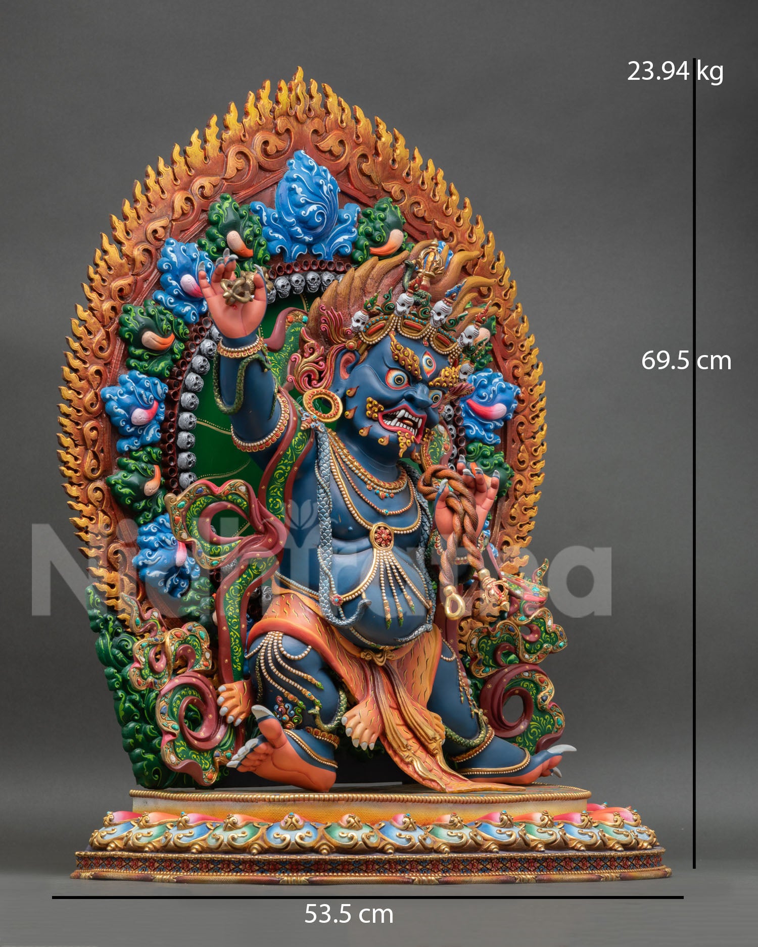 Side view of Vajrapani statue dynamic warrior pose vajra in right hand lasso in left hand symbolic protection control over negative forces Vajrayana art