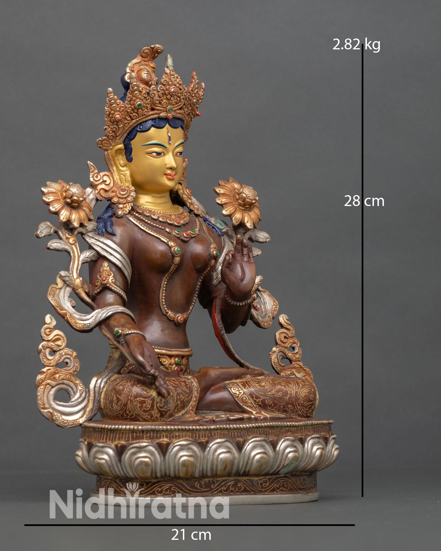 Side view of White Tara statue with silver plated details and gold gilded accents crafted using lost wax casting Nepal