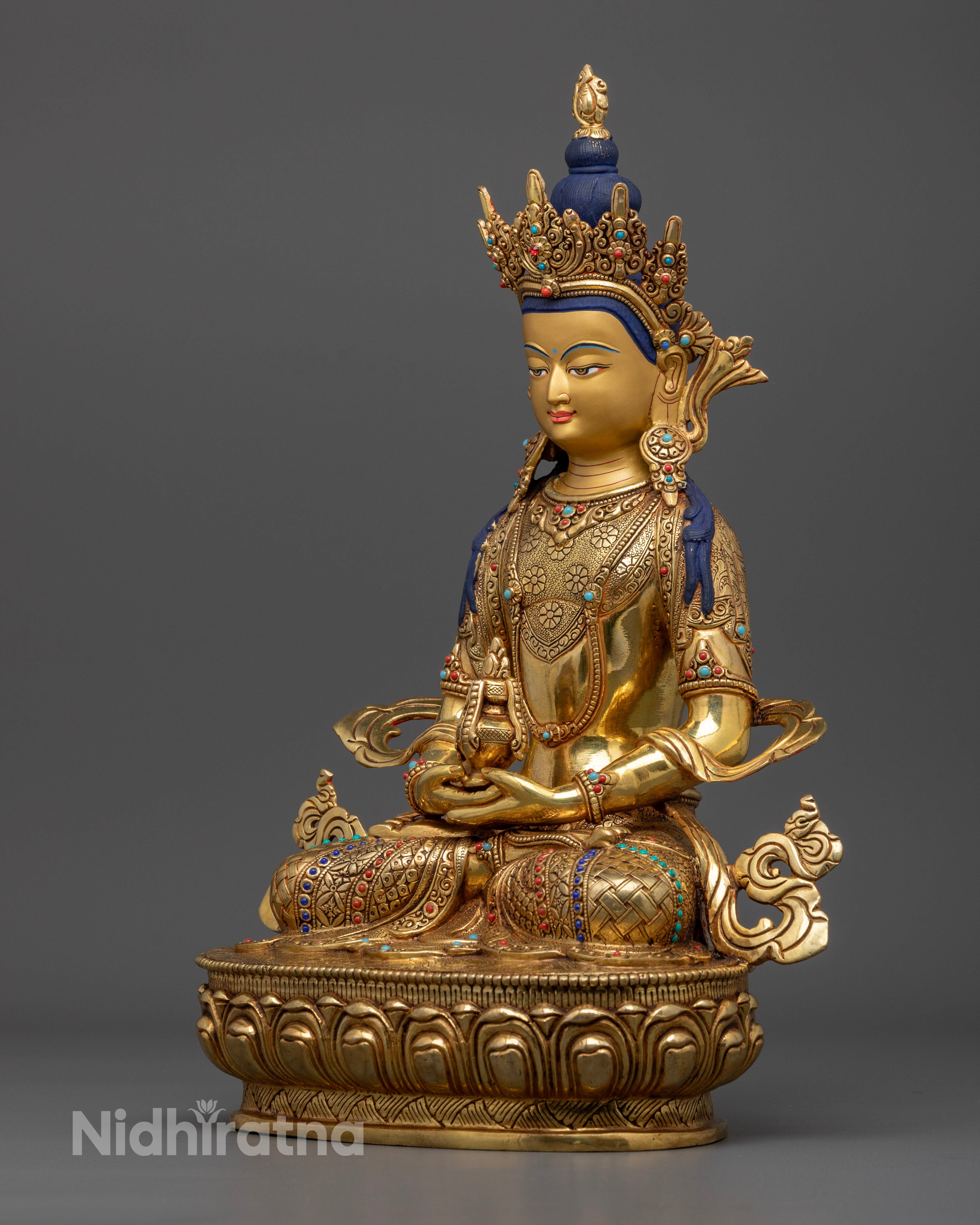side profile view of gold coated amitayus buddha statue
