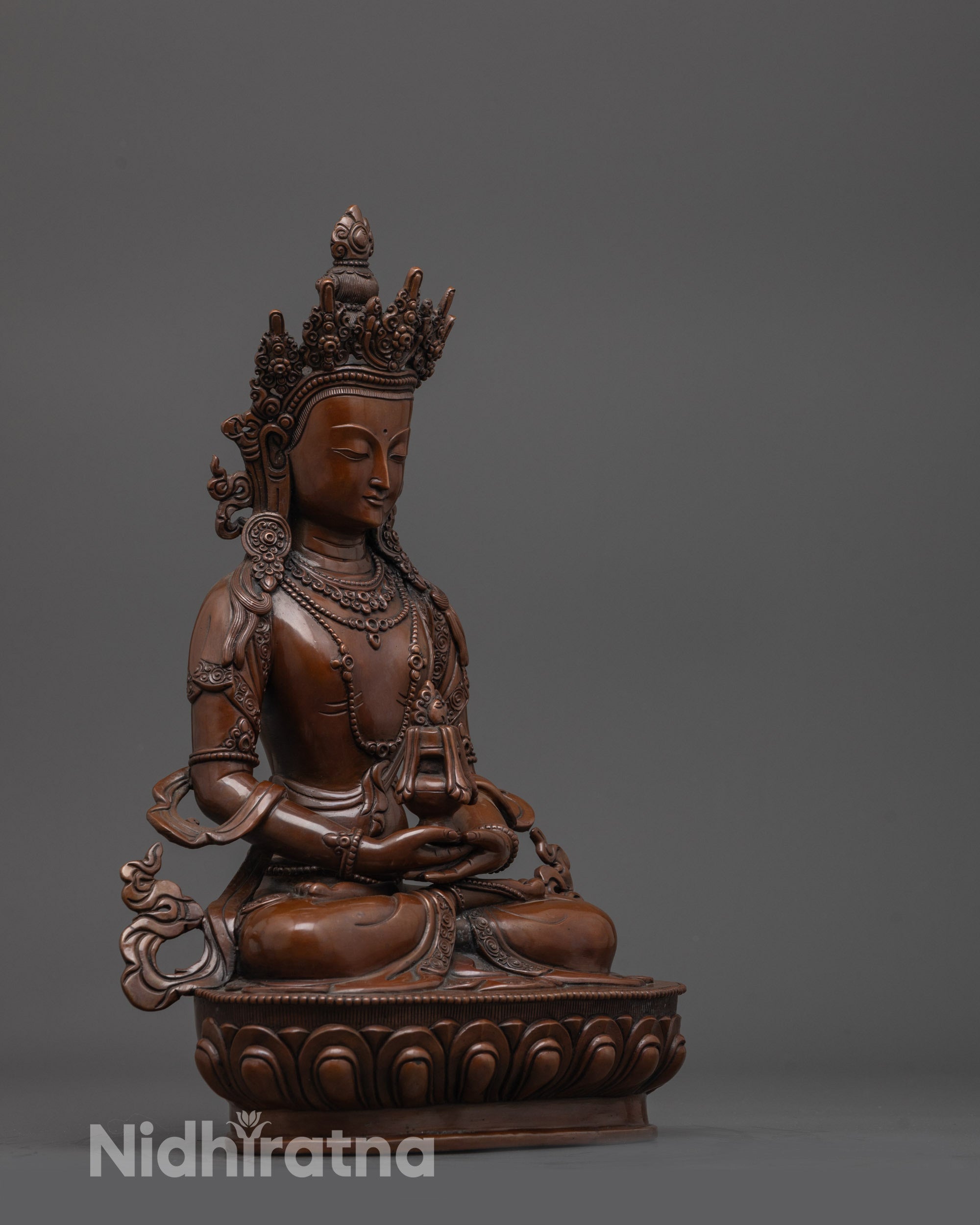 side angle of Amitayus statue showing flowing robes and nectar vase in dhyana mudra