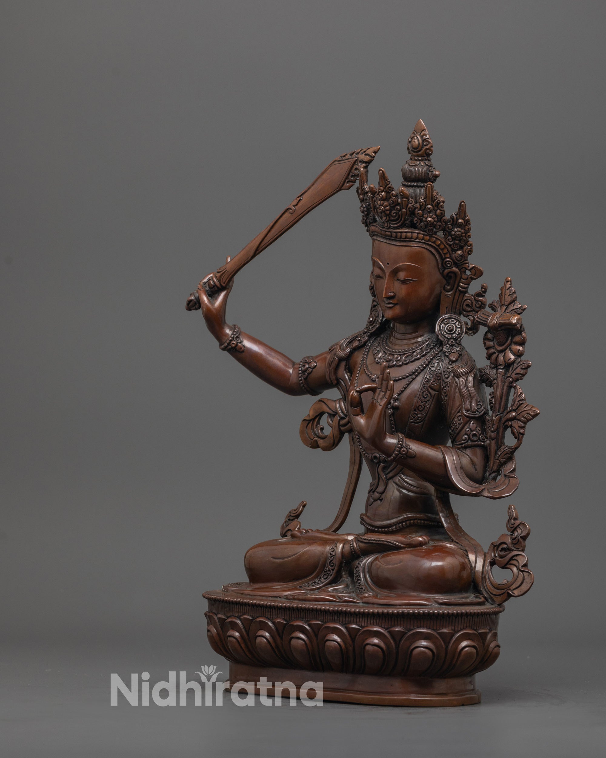 side angle of Manjushri statue seated in on lotus base