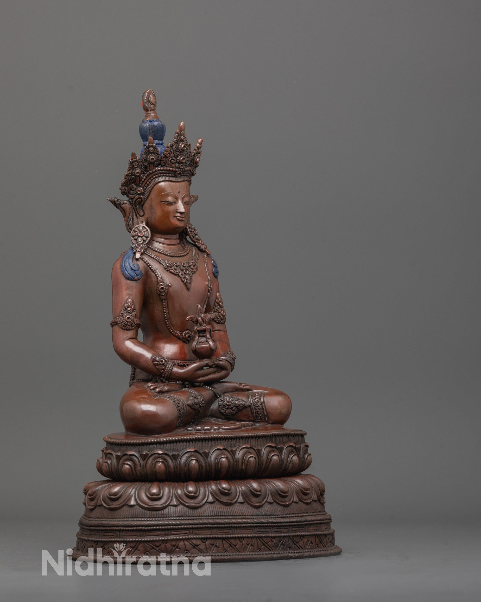 side angle of Tibetan Amitayus statue seated in meditation with oxidized copper body finish