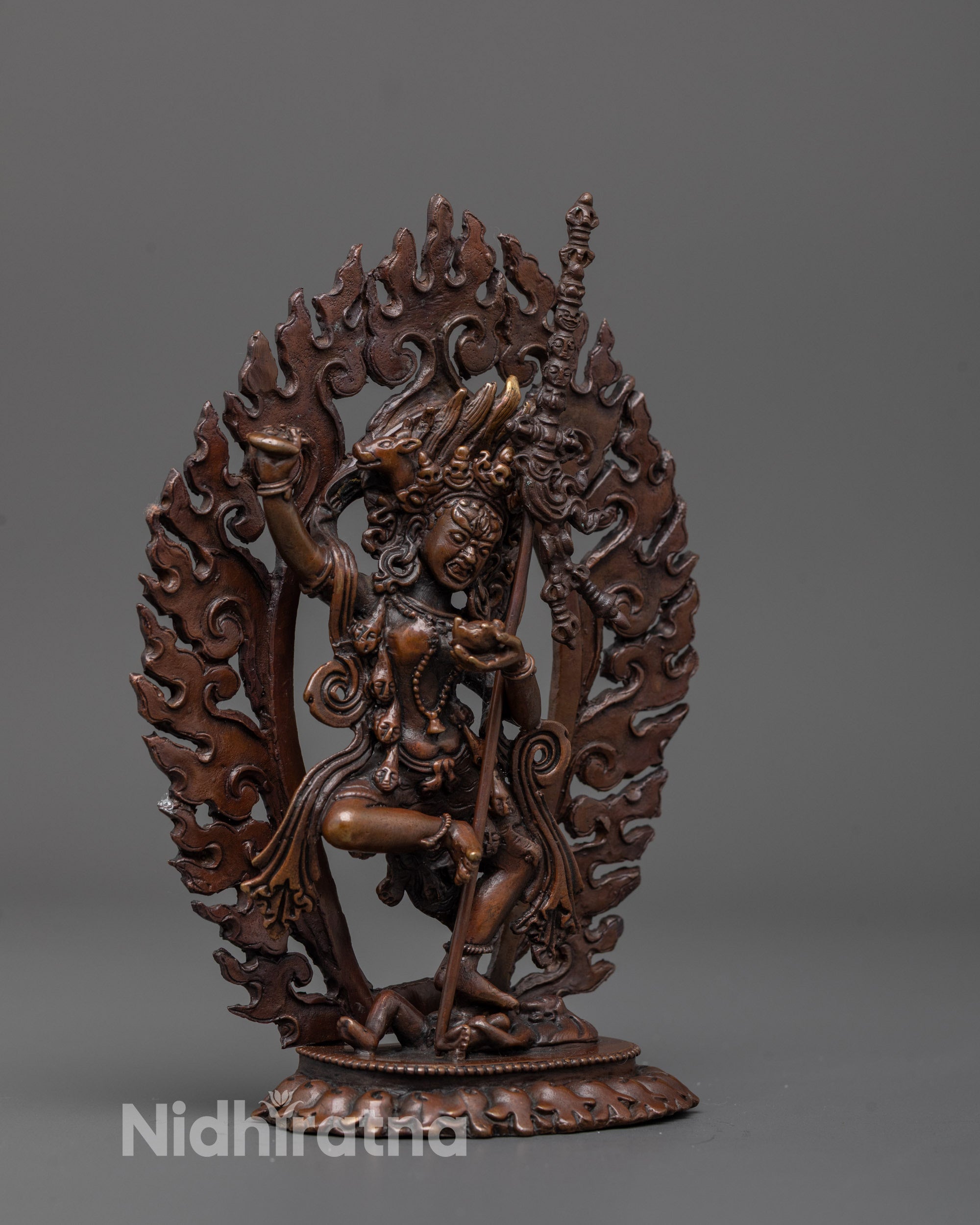 side angle of dorje phagmo statue with intricate flowing robes and bold deity-crushing pose