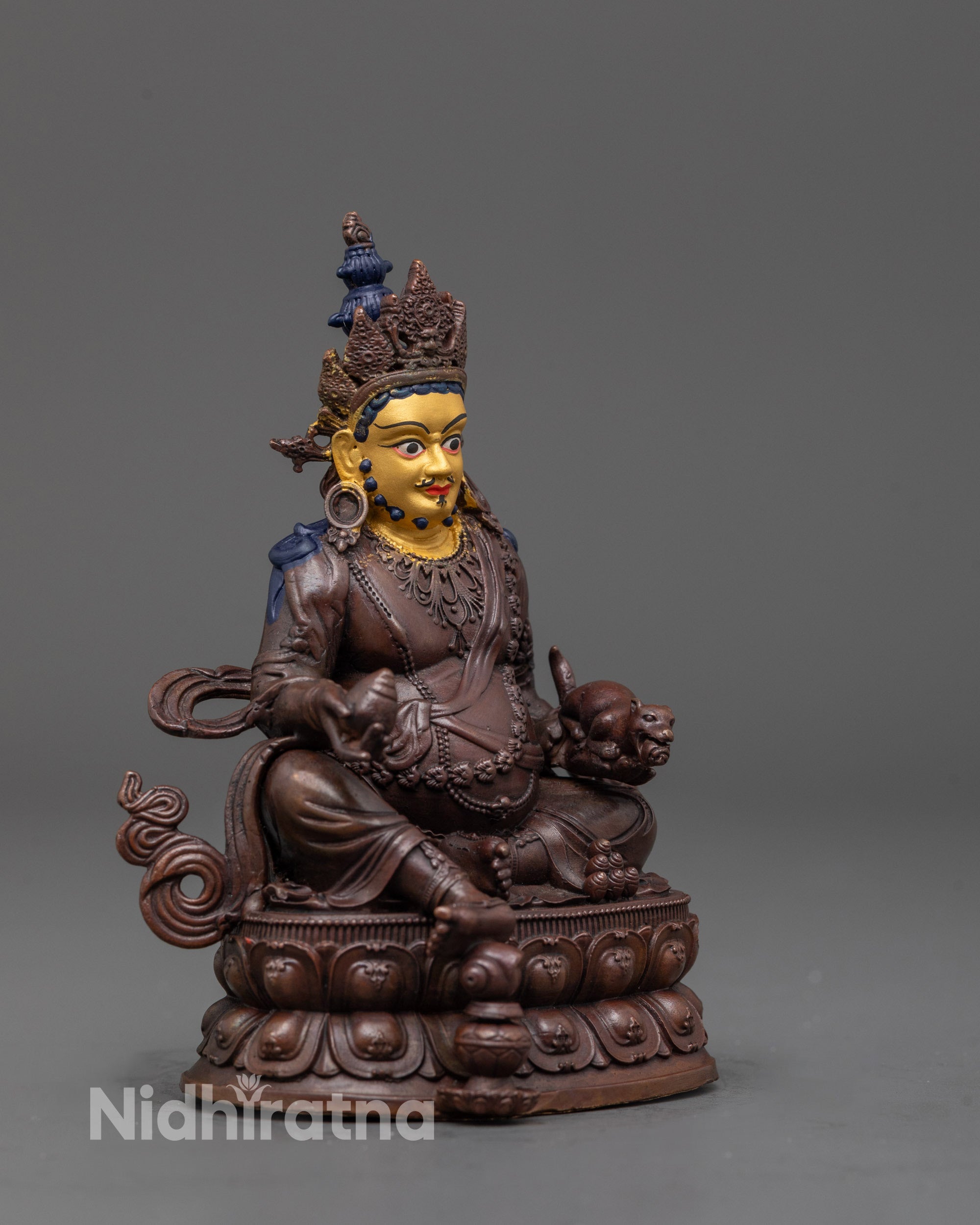 side angle of machine-made Dzambhala statue showing electroplated copper finish