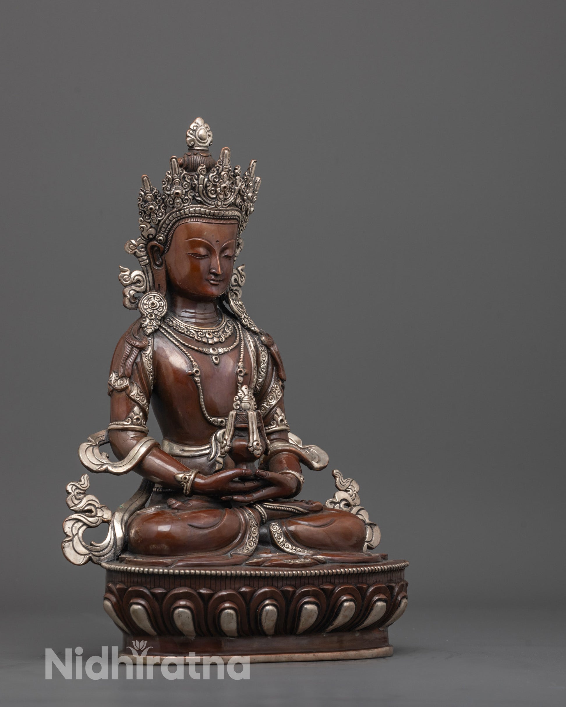 side angle of oxidized copper amitayus deity statue seated in dhyana mudra on lotus base