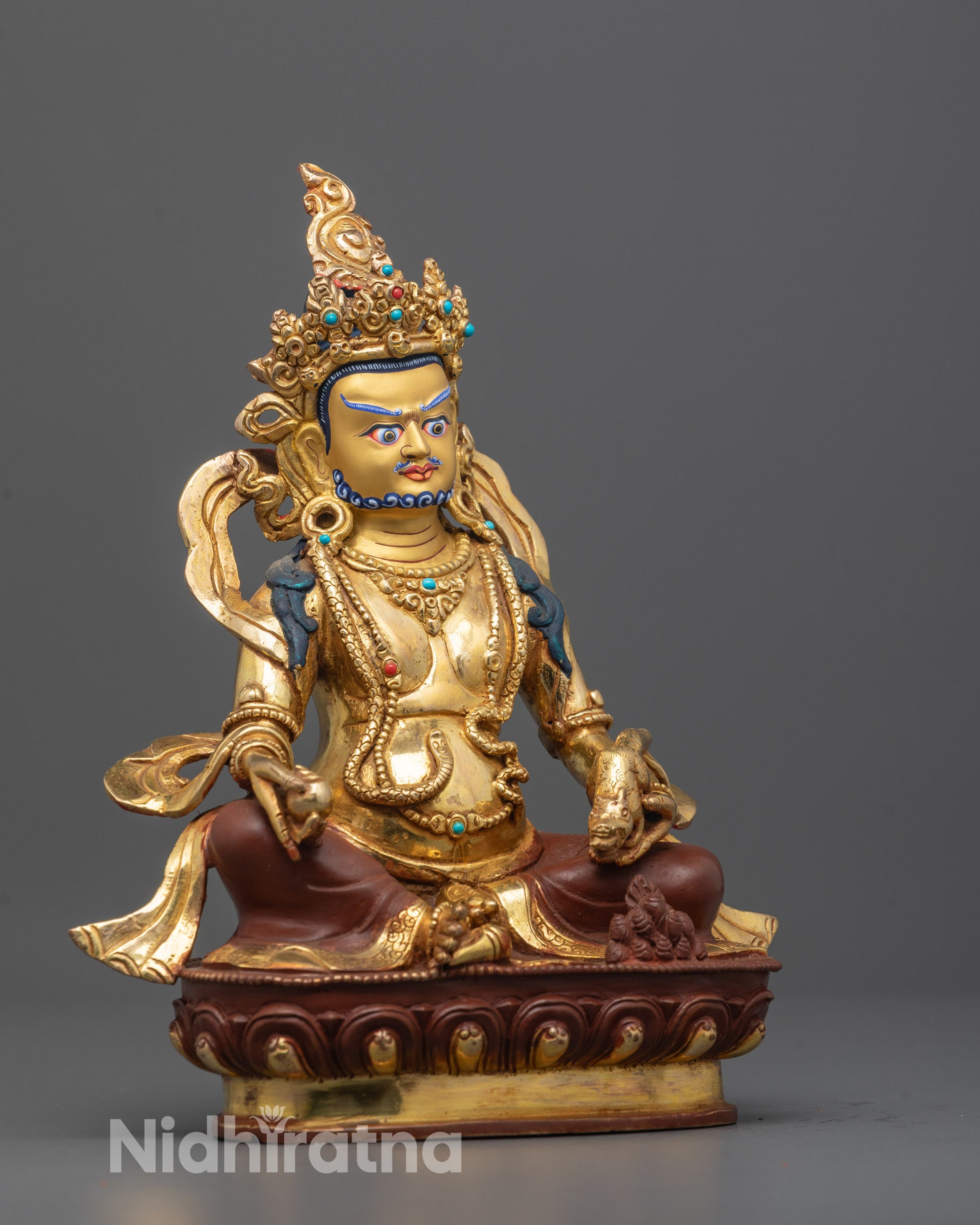 side angle view of God of Wealth Dzambhala with intricate carvings and adorned body ornaments