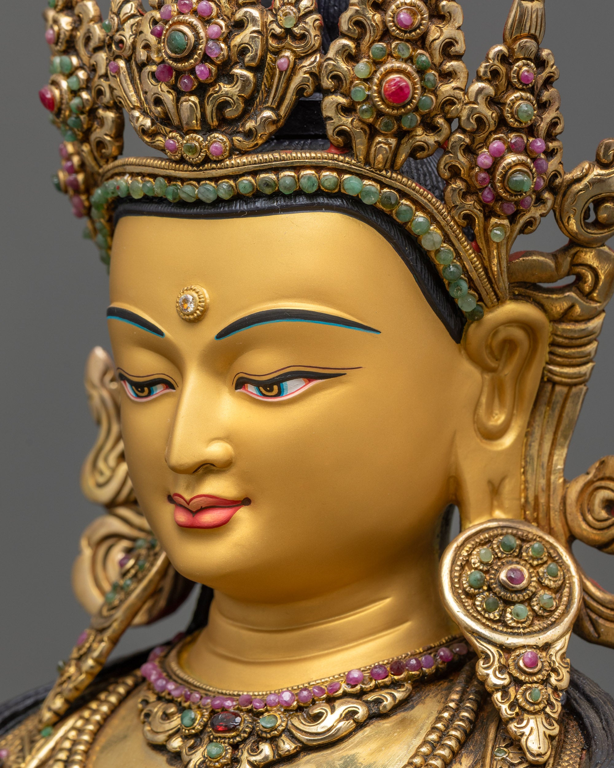 side close up face Vajrasattva statue showing vajra and bell symbolizing method and wisdom