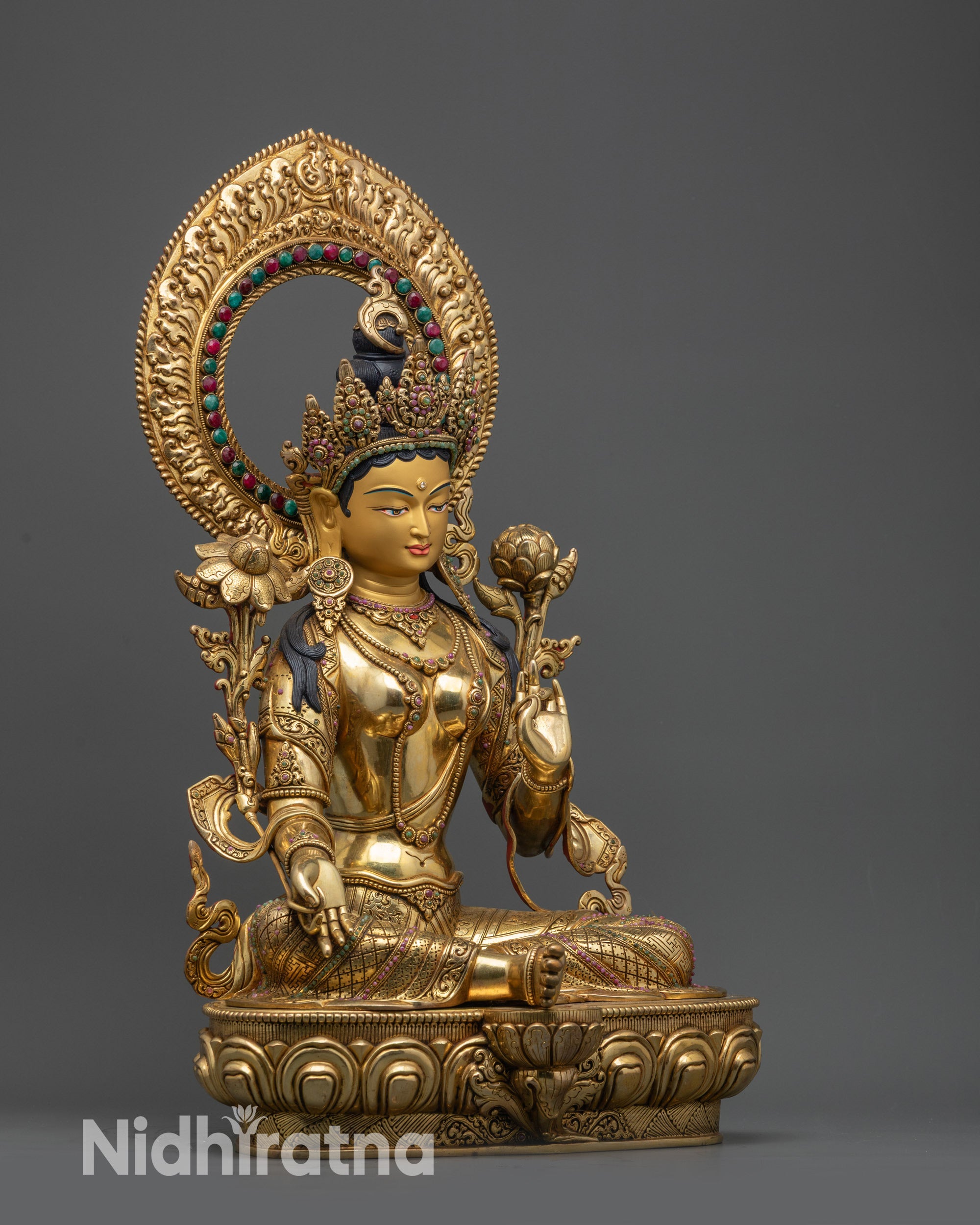 side view Green Tara statue seated on double-layered lotus base with gold-gilded face