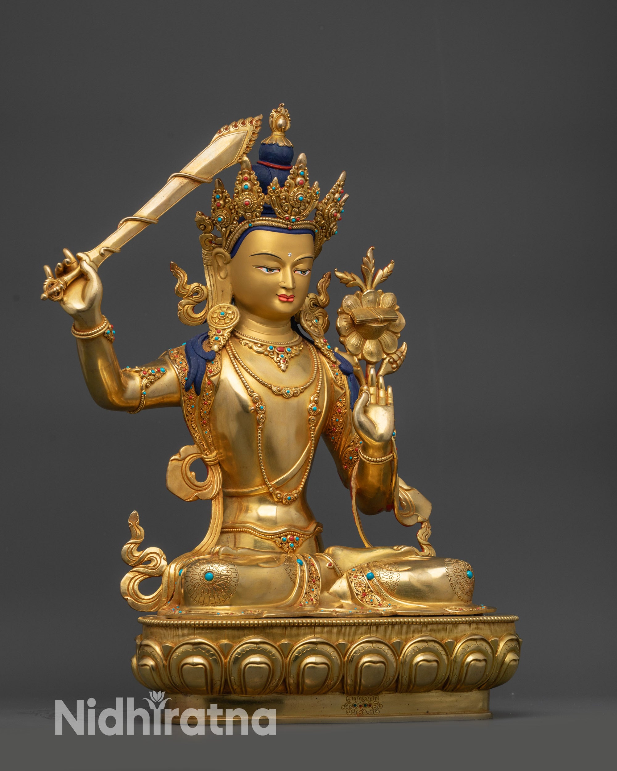 side view Manjushri statue with intricate robe and lotus throne