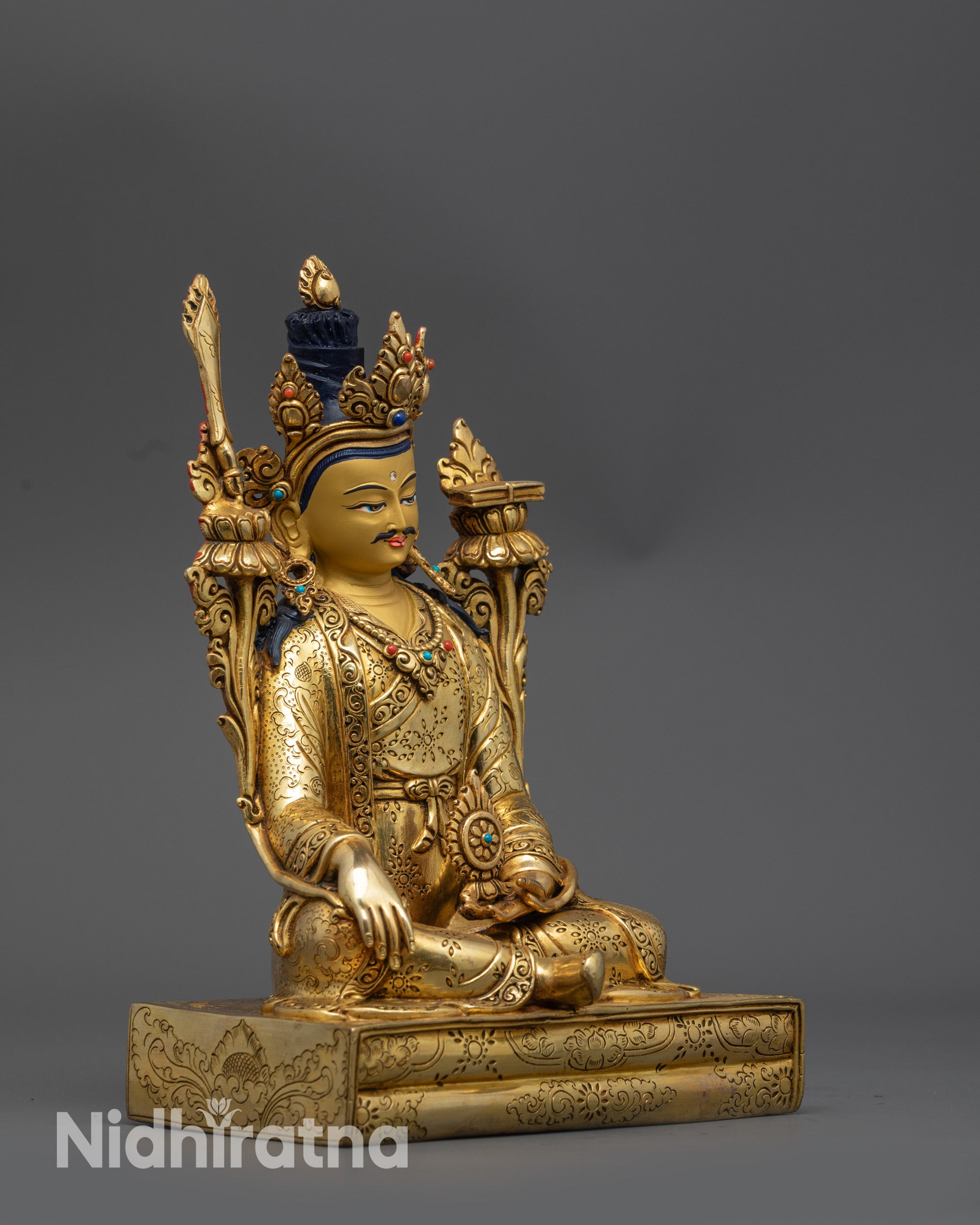 side view Tibetan King Trisong Detsen sculpture holding utpala flowers and dharma wheel