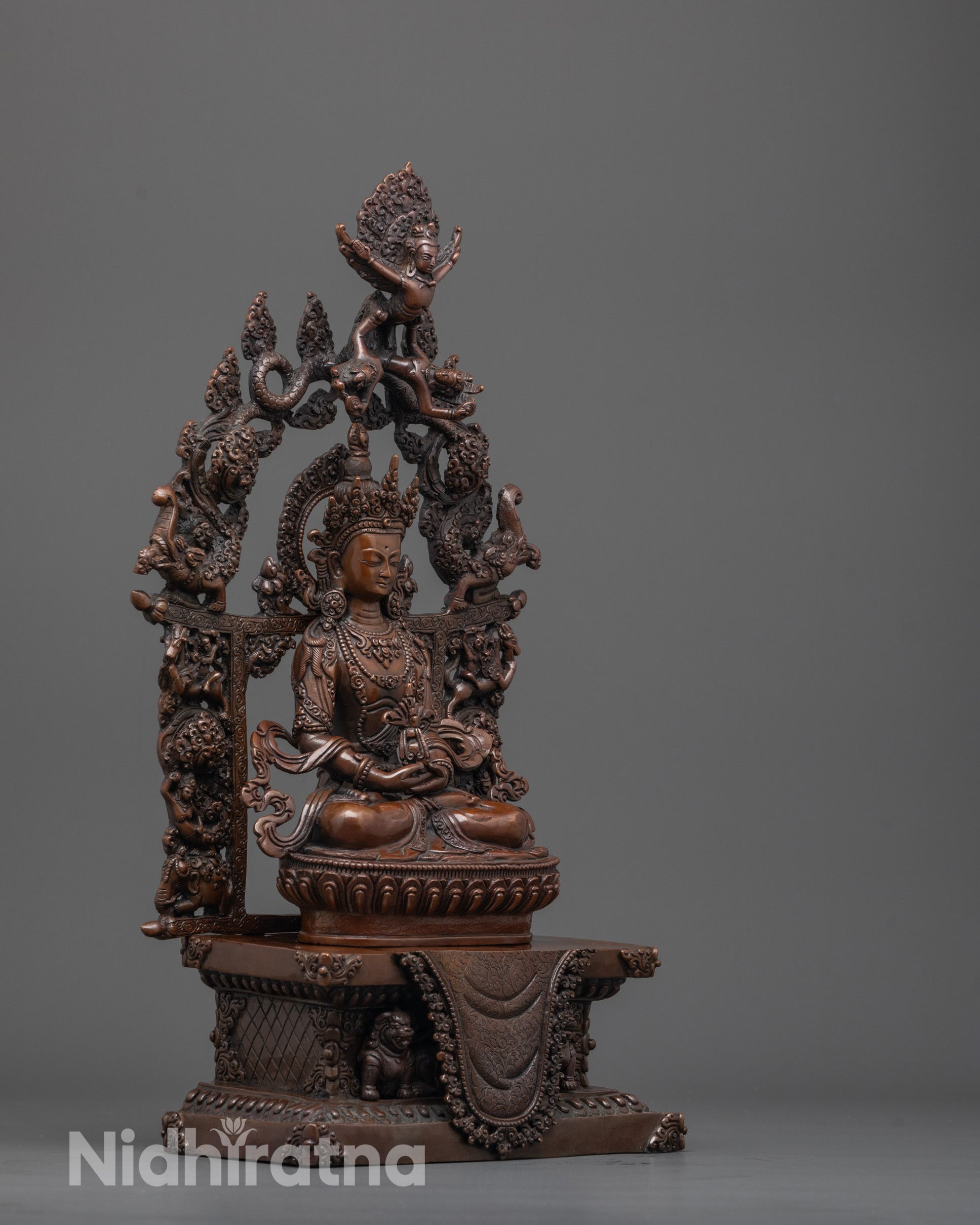 side view of Amitayus statue highlighting halo with sculpted deities and serene mudra